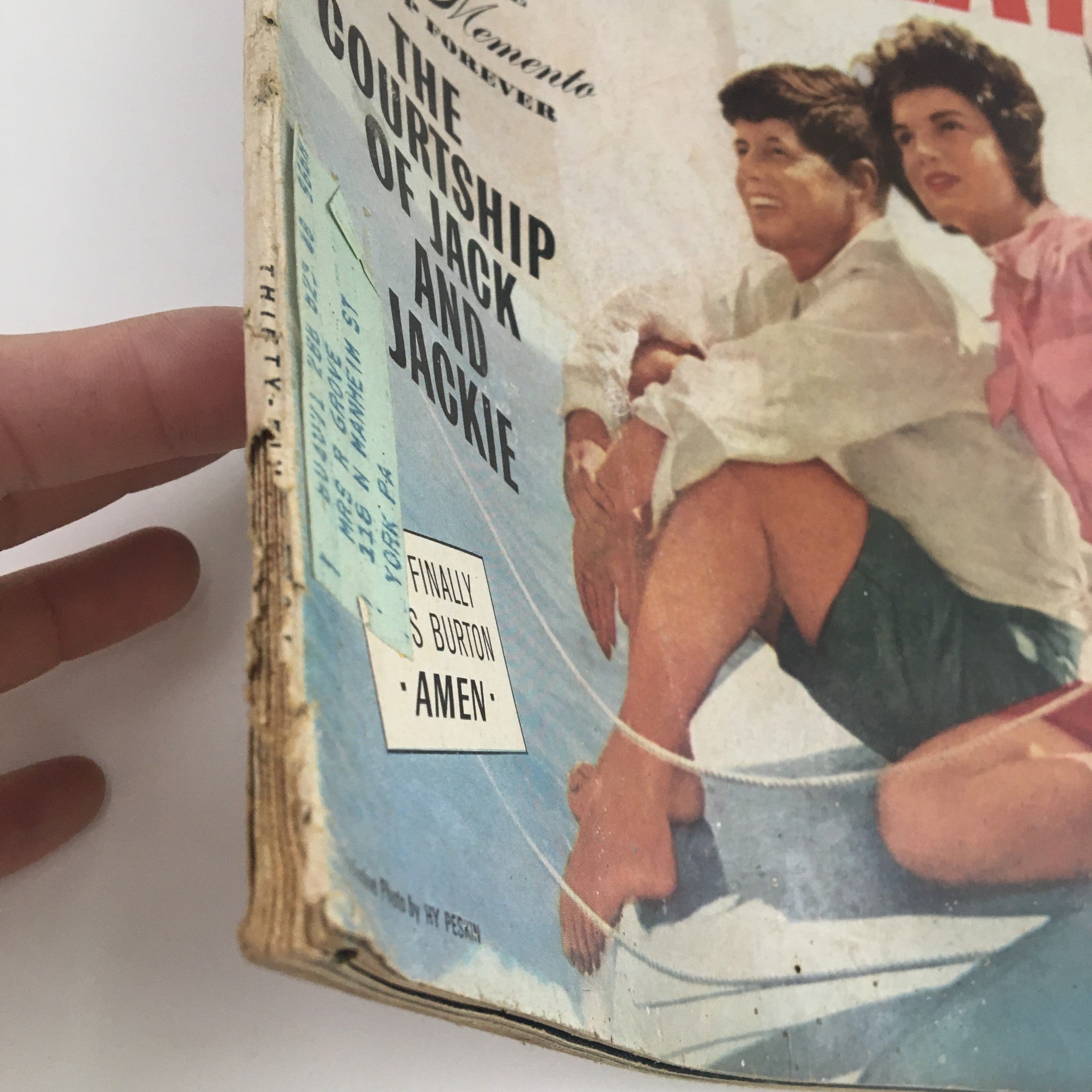 Side view of Photoplay Magazine March 1964, depicting the courtship of Jack and Jackie, showing wear on the spine and the magazine's address label for authenticity.