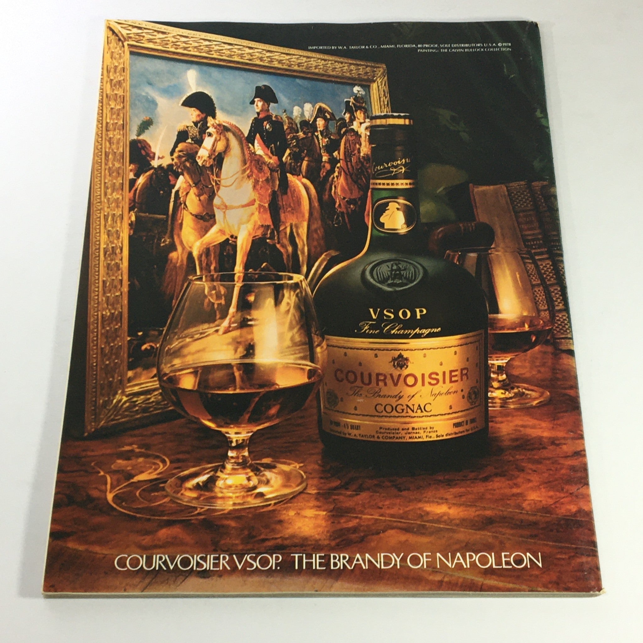 Vintage advertisement for Courvoisier VSOP, featuring a bottle of cognac and a glass, set against a historical backdrop related to Napoleon, illustrating 'Gourmet The Magazine of Good Living May 1979 - Chez Don Camillo Cheese Tray'.