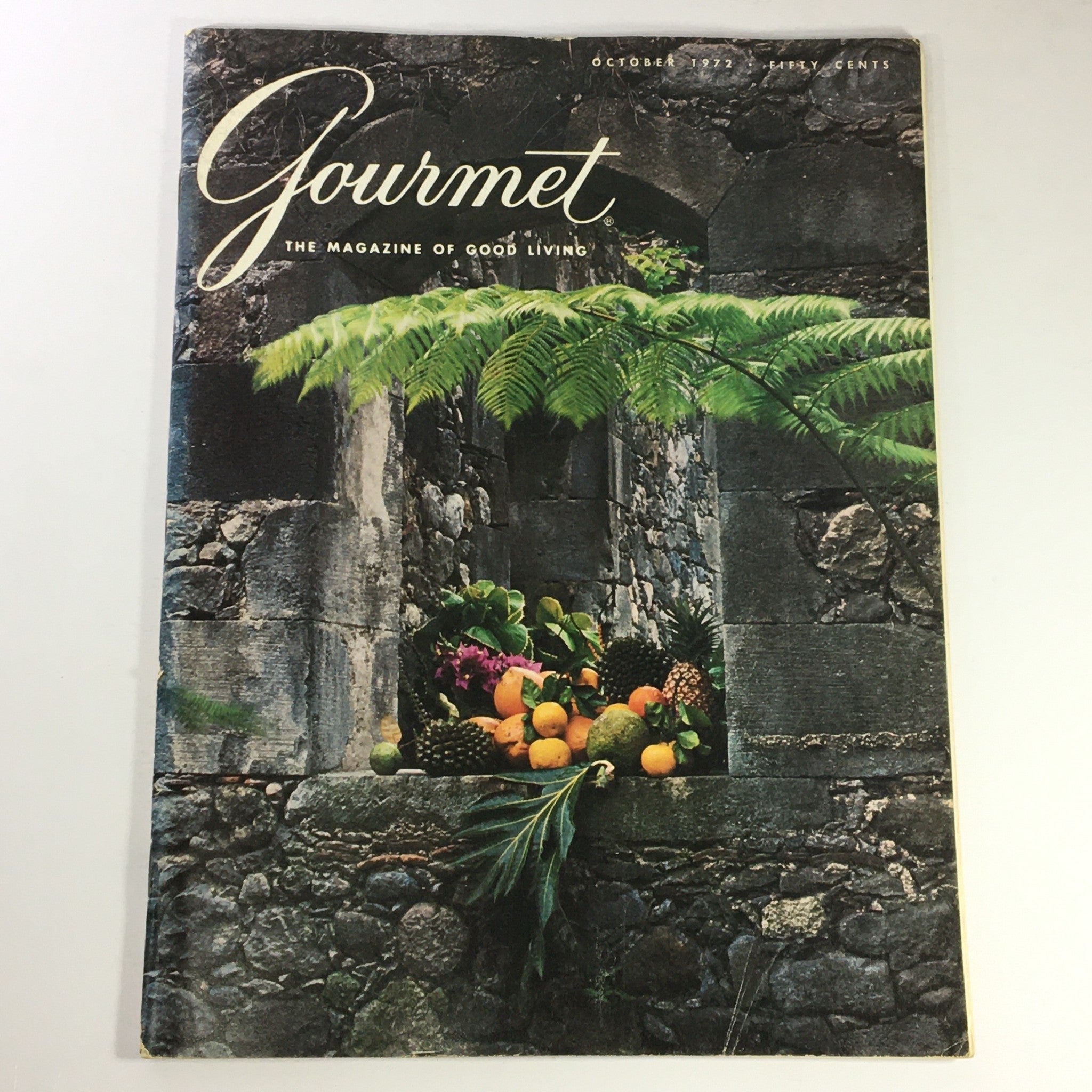 Cover of VTG Gourmet The Magazine of Good Living, October 1972 featuring a stone wall adorned with a variety of colorful fruits and greenery, highlighting the charm of Taormina, Sicily.