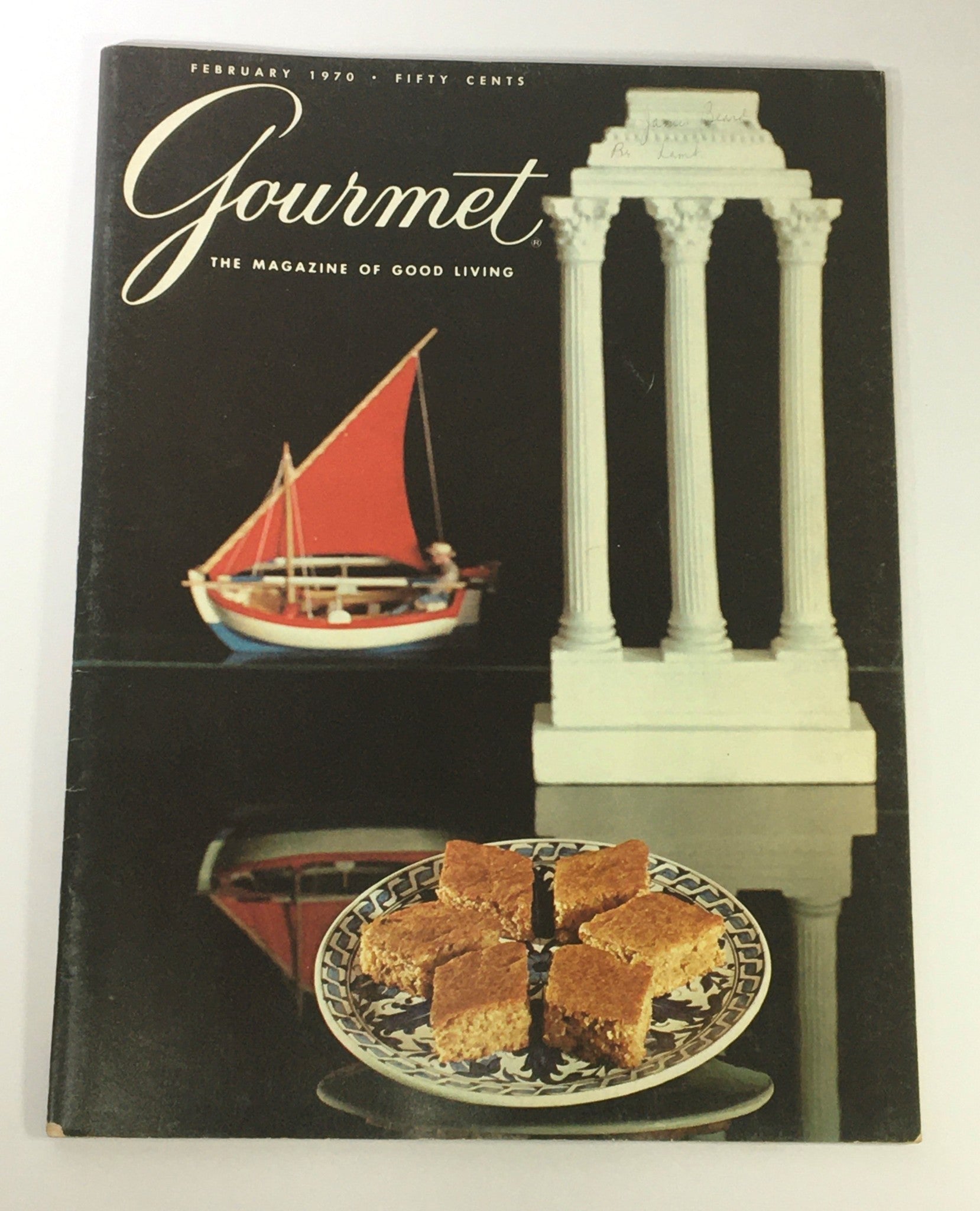Gourmet The Magazine of Good Living February 1970 cover featuring a gourmet dessert on a plate and a decorative boat in the background.
