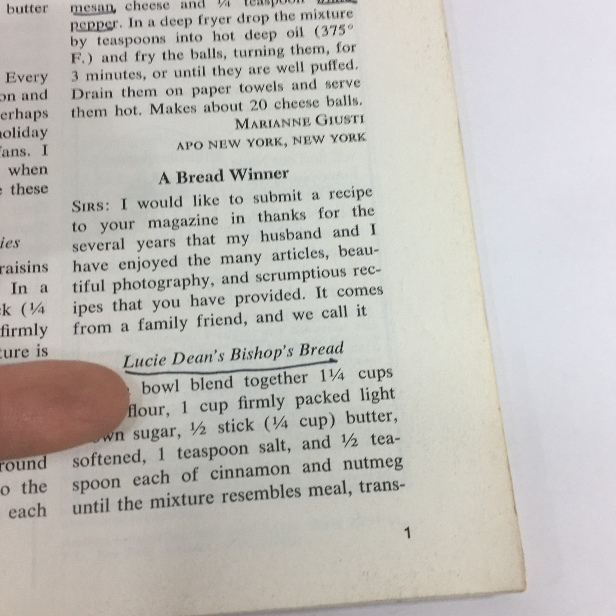 Close-up of a recipe titled 'Lucie Dean's Bishop's Bread' from VTG Gourmet Magazine February 1977, highlighted with a finger pointing to the ingredients and instructions.
