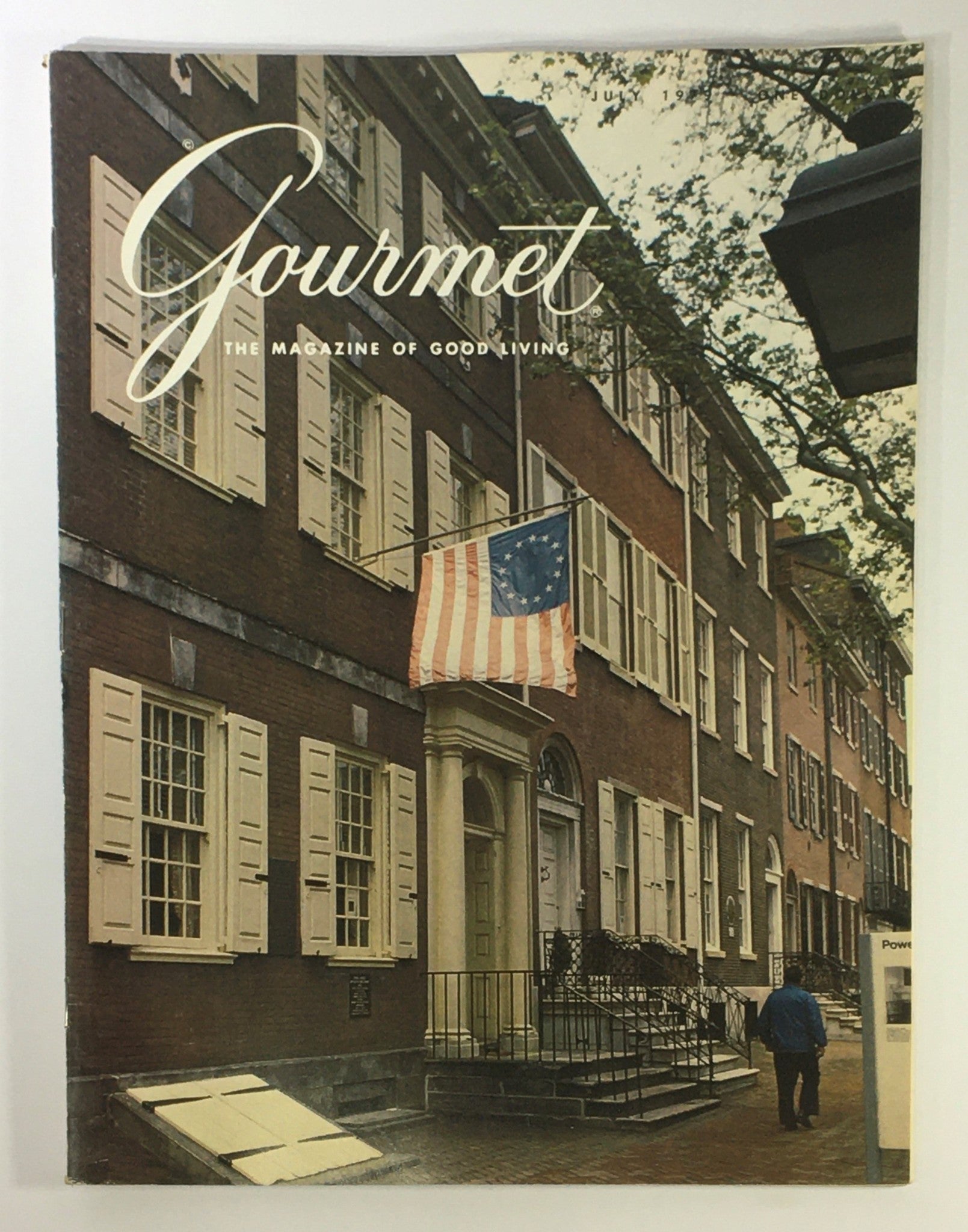 Cover of VTG Gourmet The Magazine of Good Living July 1979 featuring historical architecture and an American flag, related to the theme 'In Search of Victor Hugo'.