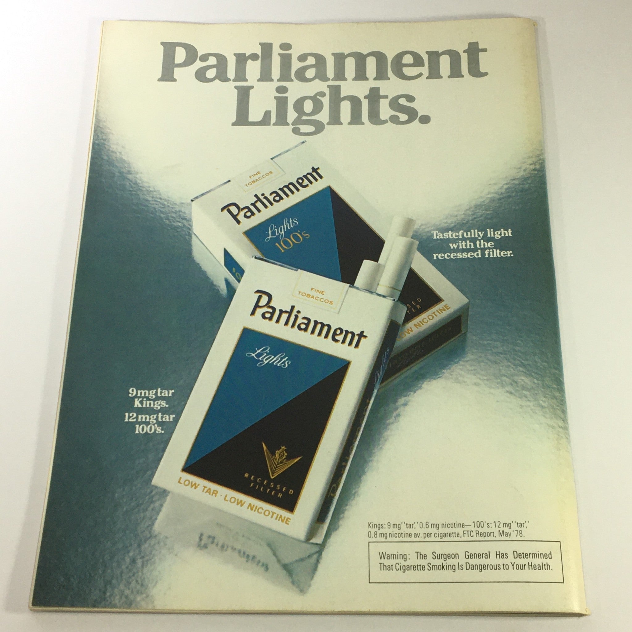 Advertisement for Parliament Lights cigarettes showcasing the packaging design, highlighting the lower tar and nicotine content.