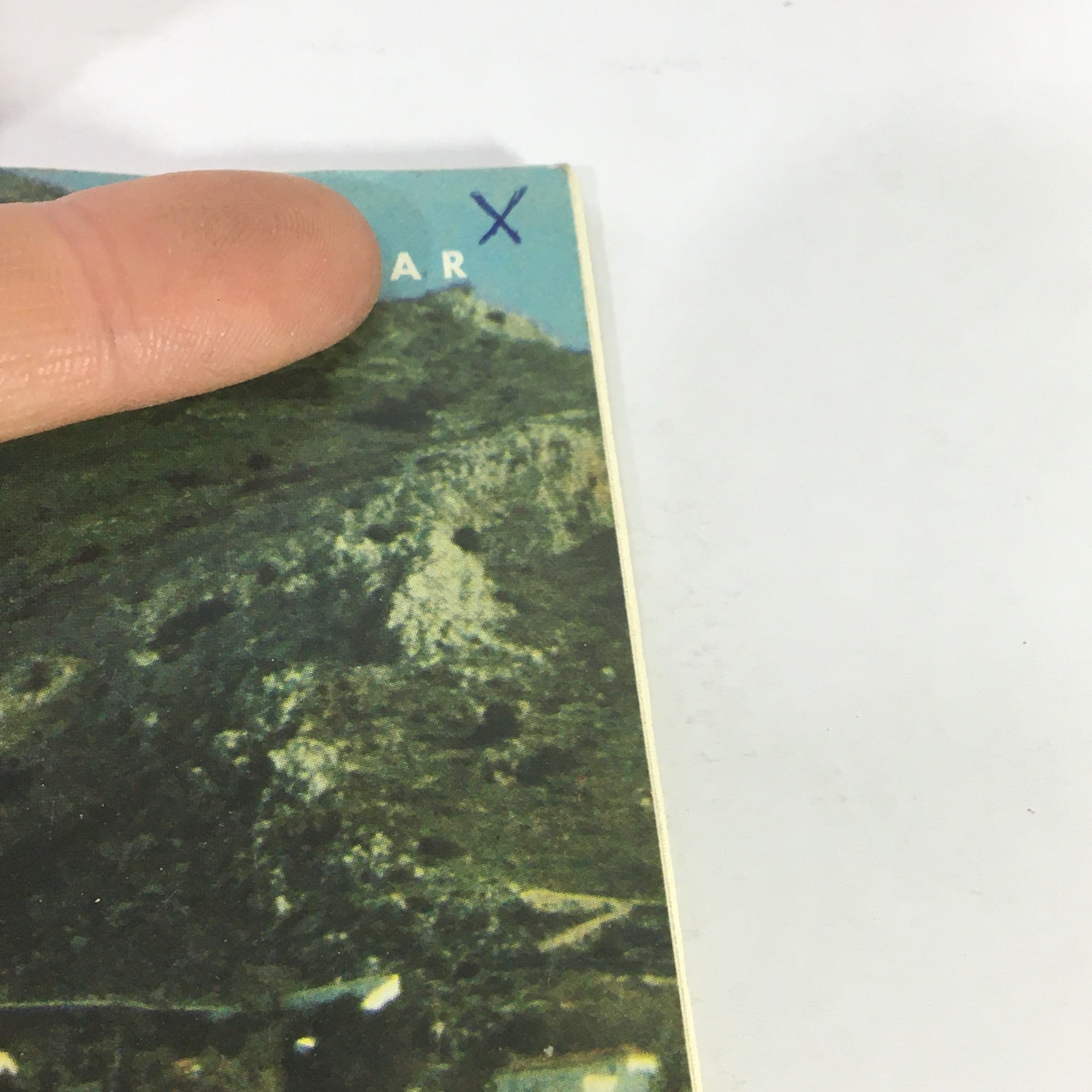 Close-up of the corner of VTG Gourmet: The Magazine of Good Living, August 1978, showing publication details and a finger pointing to the top.