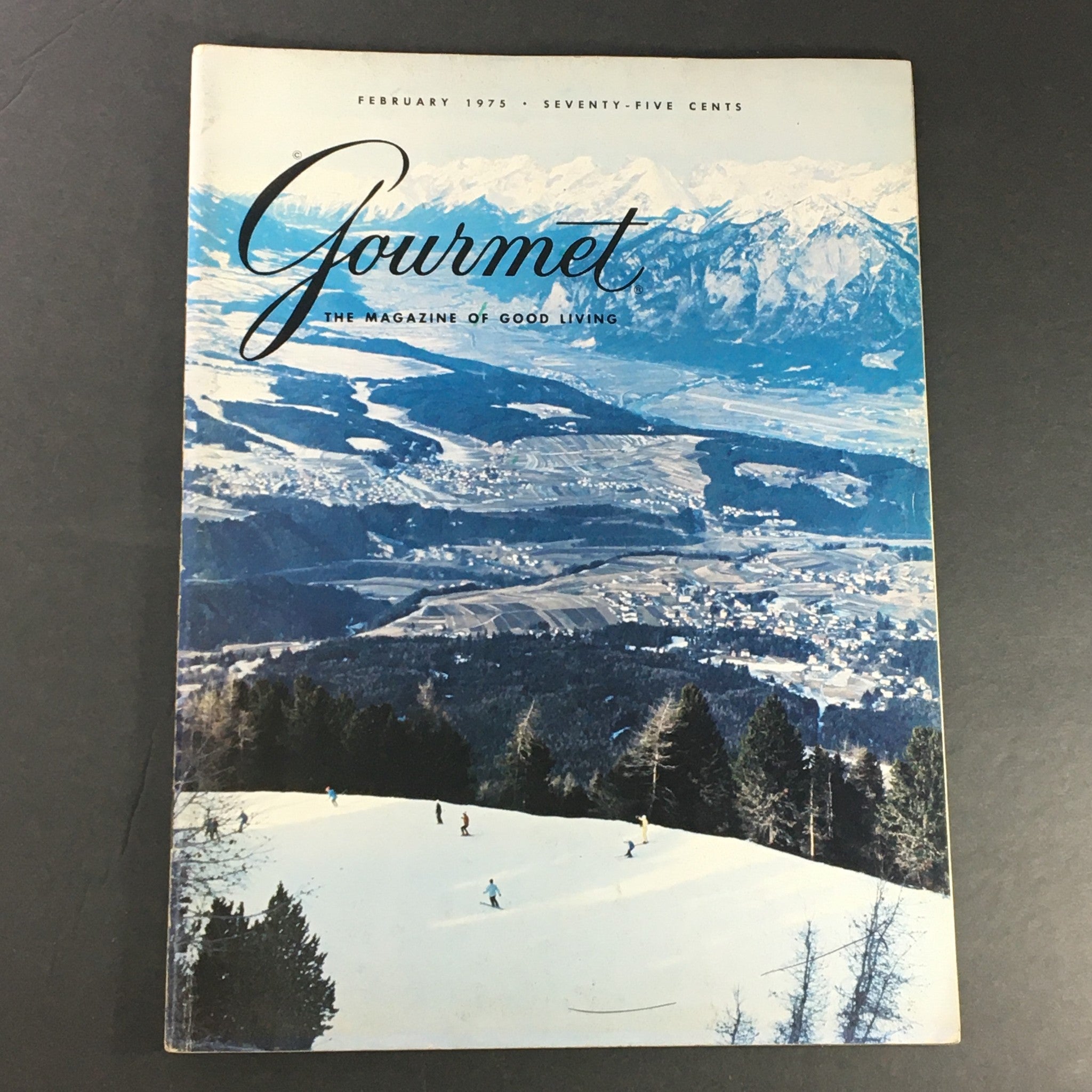 Cover of Gourmet The Magazine of Good Living, February 1975 issue featuring a stunning Tyrolean landscape with snow-covered slopes and skiers, showcasing the essence of gourmet living.