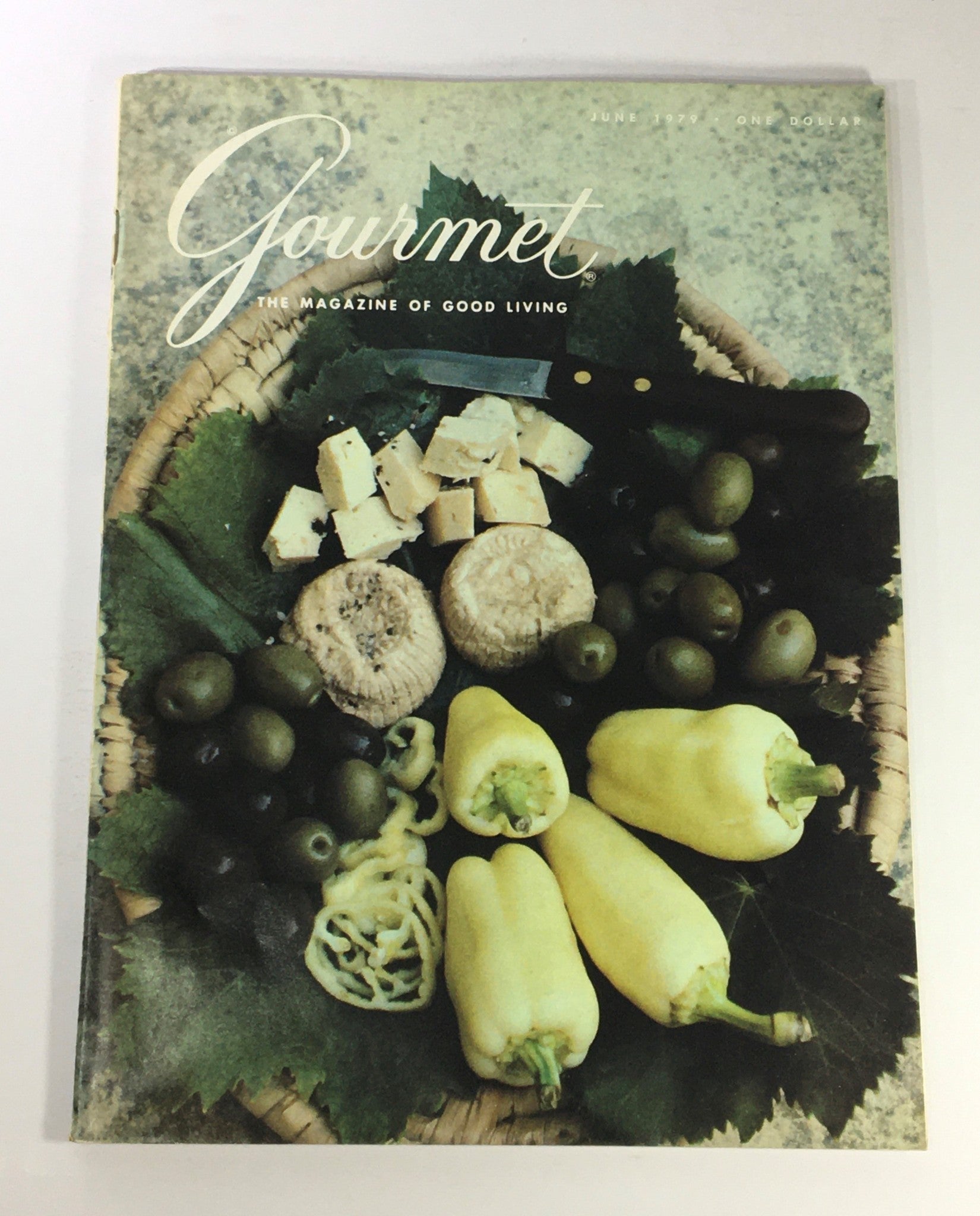 Front cover of VTG Gourmet The Magazine of Good Living June 1979, featuring a vibrant arrangement of gourmet foods including cheeses, olives, and peppers set on a decorative basket, showcasing culinary creativity of the late 1970s.