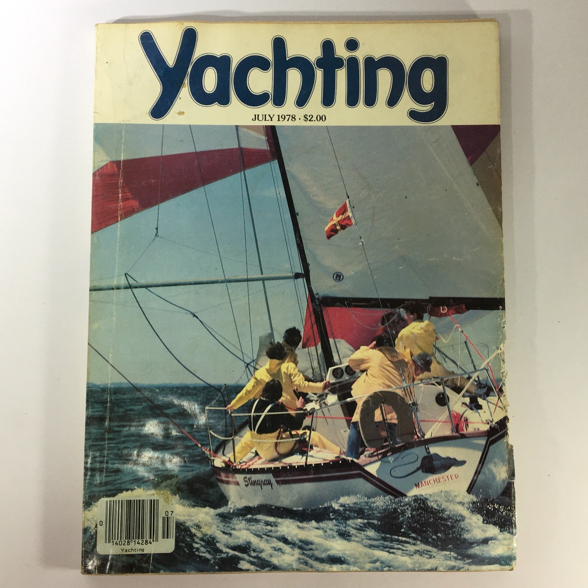 Front cover of VTG Yachting Magazine July 1978 featuring an action shot of sailors in yellow jackets on a sailboat amidst ocean waves, showcasing Alastair Black's photography style.