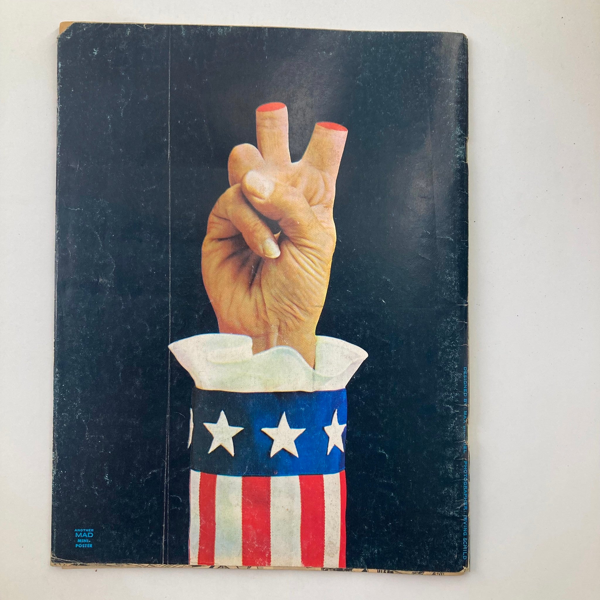 Back cover of Mad Magazine April 1973 No. 158 featuring a hand making a peace sign, adorned in a patriotic red, white, and blue sleeve, reflecting the cultural themes of the era.