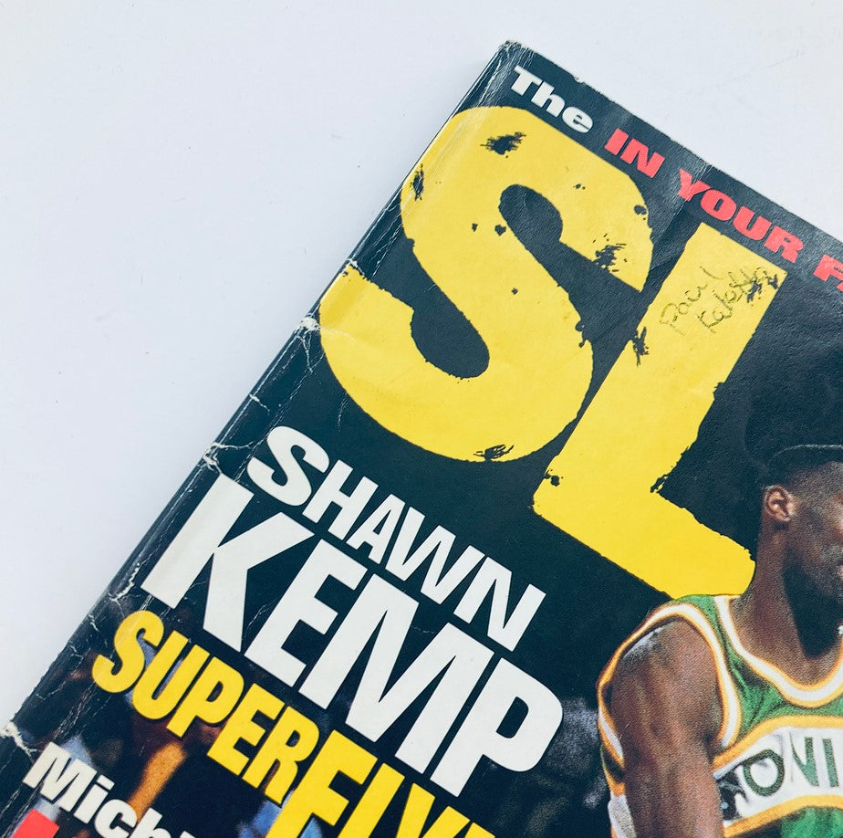 Close-up of the cover of Slam Magazine 1994 No. 2 featuring Shawn Kemp of the Seattle Supersonics, highlighting the title 'SL' and signs of wear.