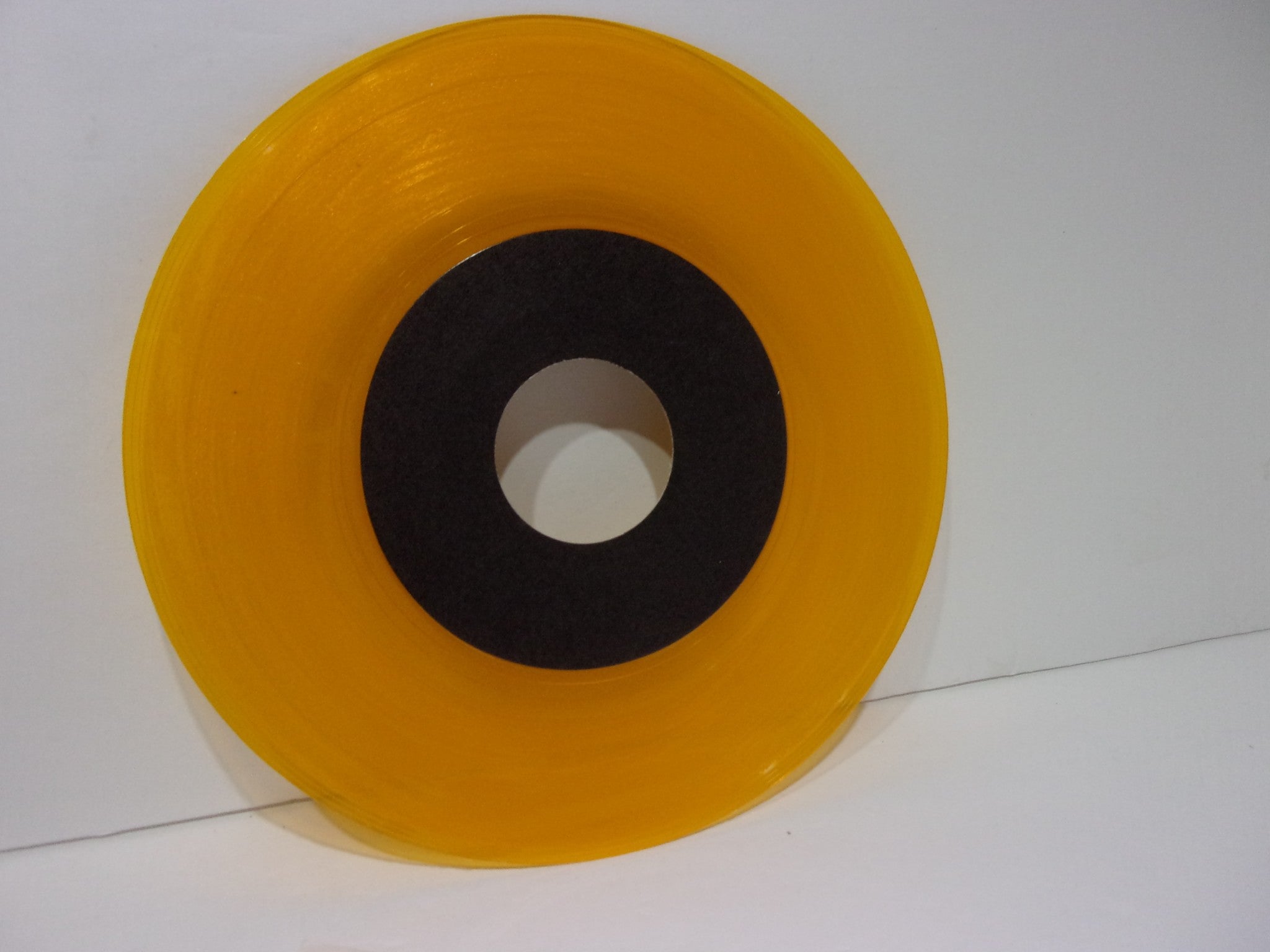 Close-up of the yellow vinyl from Straight Ahead: Spirit Of Youth EP, showcasing the vibrant color and black center label.