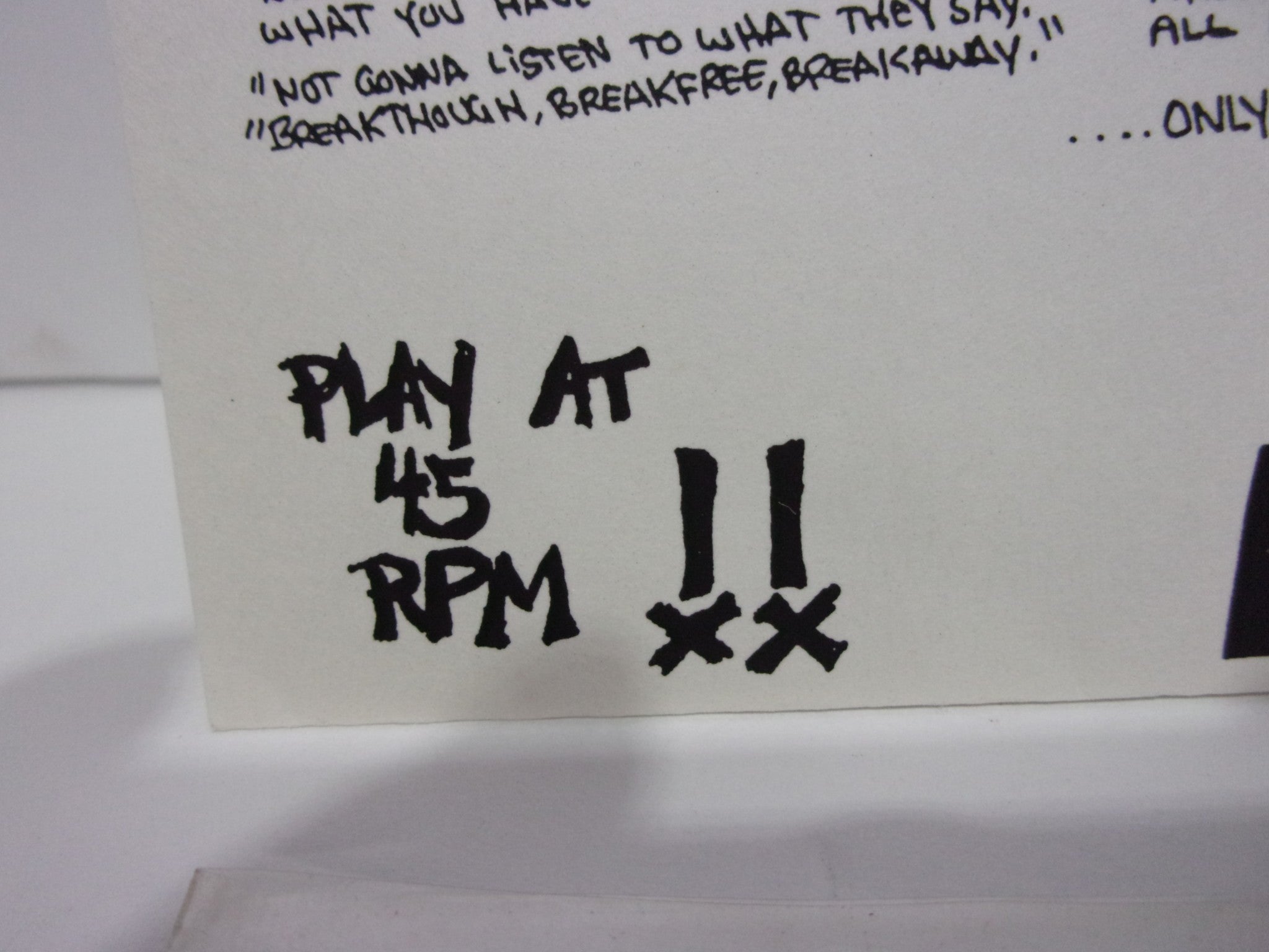 Close-up shot of the instruction on the cover of 'Straight Ahead: Spirit Of Youth I Risk Records I RISK#1 EP 7' Yellow Grade: VG+,' emphasizing 'PLAY AT 45 RPM.'