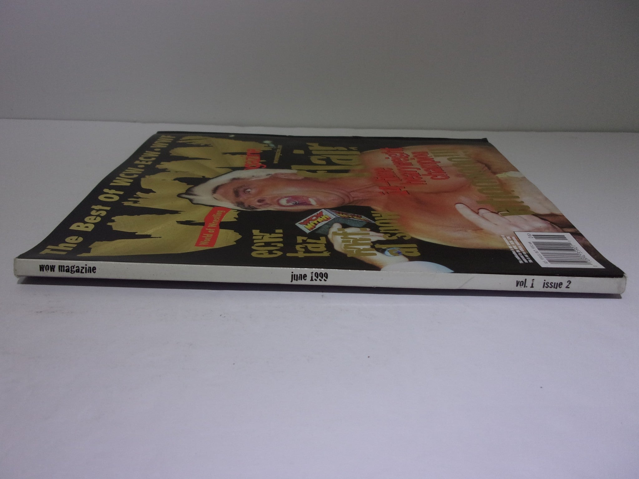 Side view of Wow Magazine: The Best of WCW - ECW - WWF June 1999 Vol. 1 Issue 2, displaying its collectible status and vintage design.