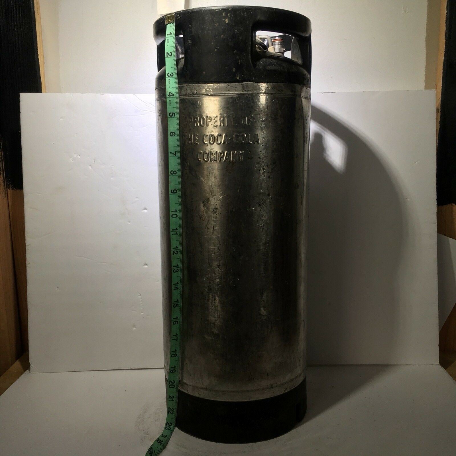 Side view of the Vintage COCA COLA Keg Syrup 5 Gallon featuring markings, perfect for collectors of rare memorabilia.