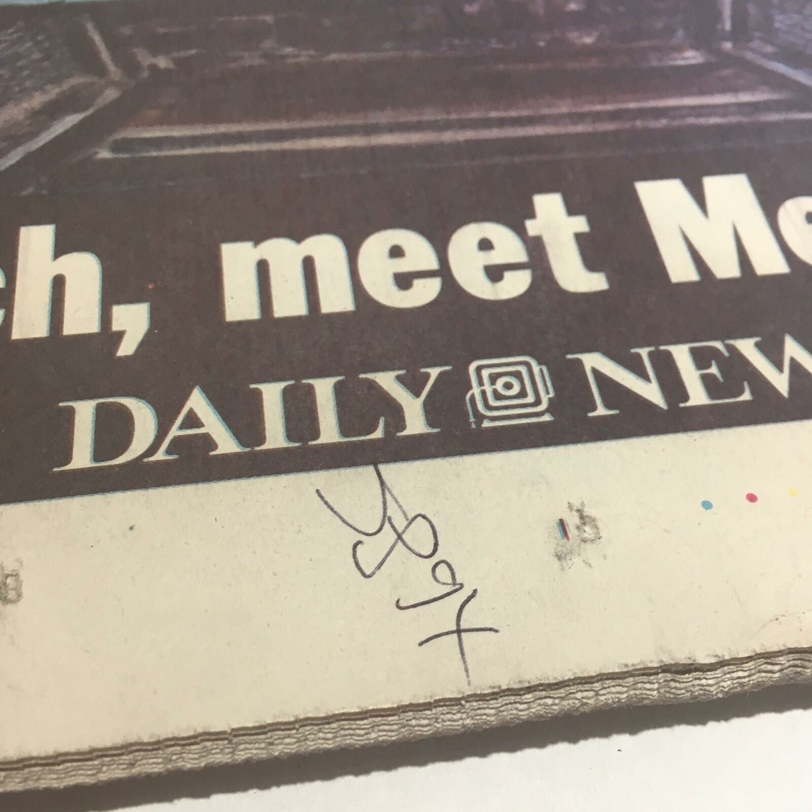 Close-up of the corner of the NY Daily News: Oct 18 2000 All Aboard! newspaper featuring a handwritten marker.