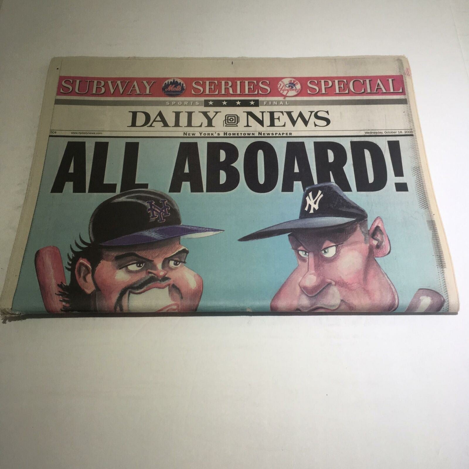 Front page of the NY Daily News: Oct 18 2000 All Aboard! showcasing characters with baseball caps and an expressive illustration.
