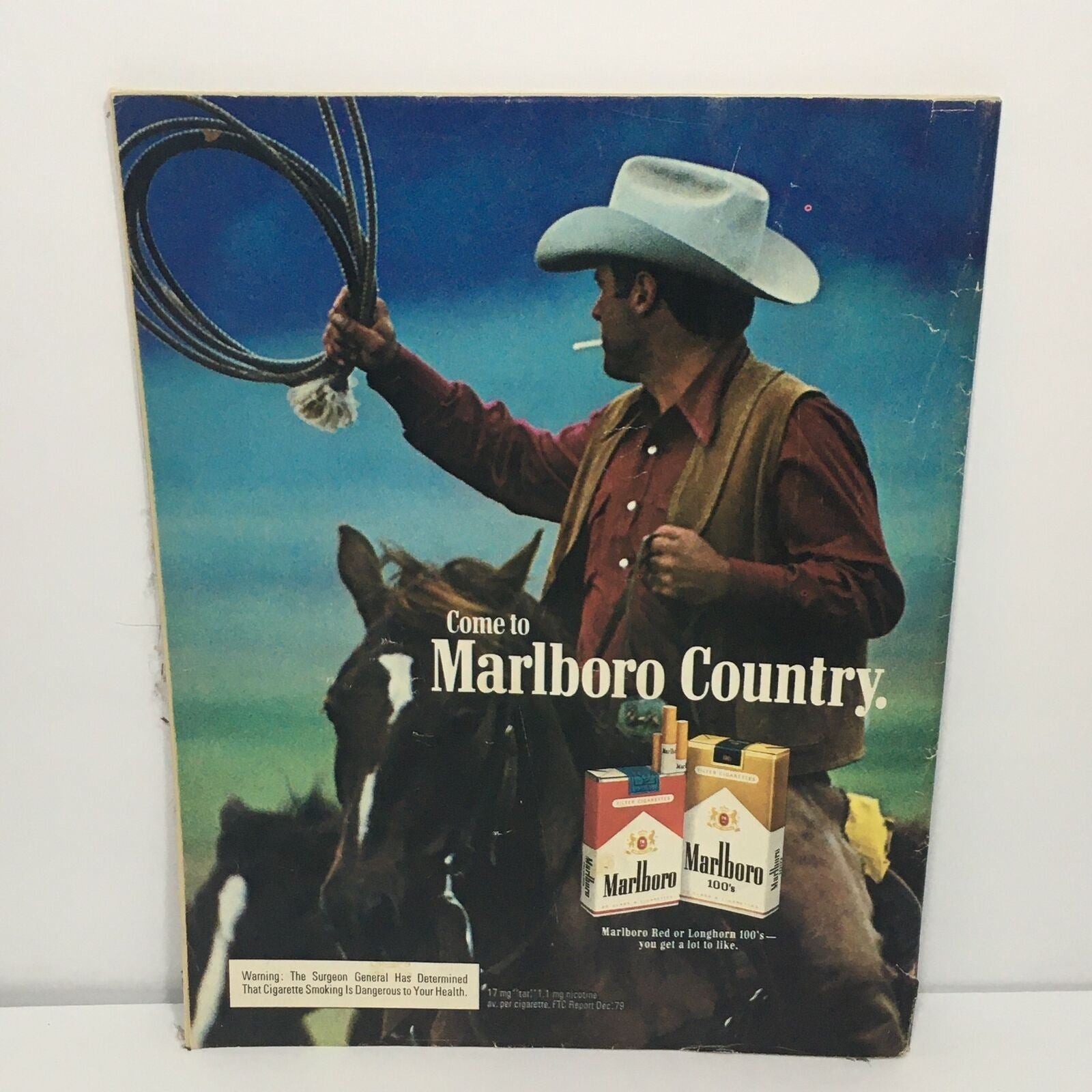 Back cover of the Grand Slam Royals Official Magazine 1980 Second Edition featuring an advertisement for Marlboro Country, with a cowboy holding a lasso against a scenic backdrop.