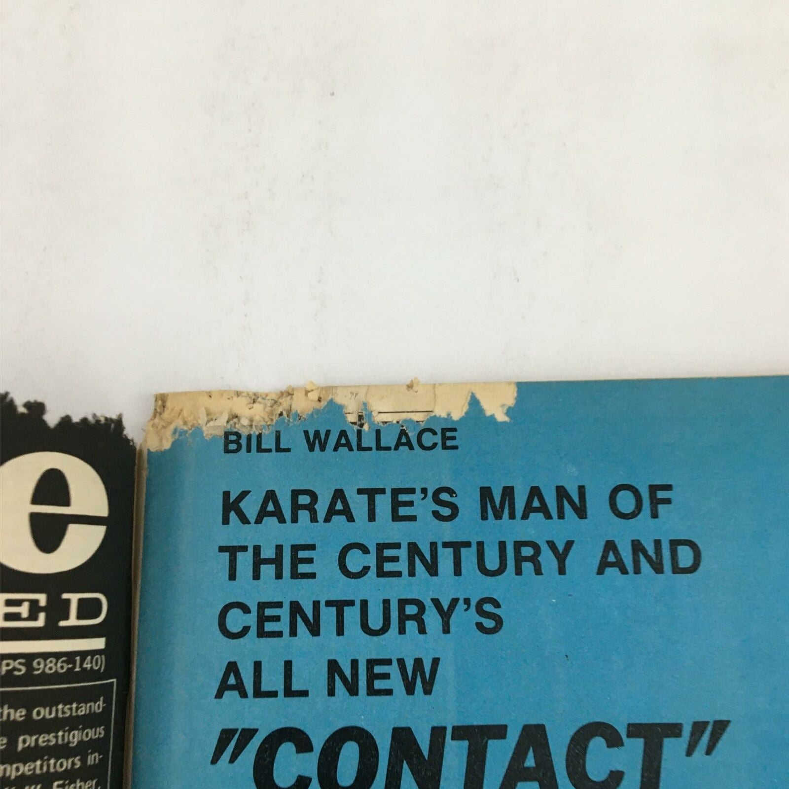 Close-up view of the top corner of the Karate Illustrated Magazine December 1979 featuring Bill Wallace, showcasing wear and tear, with faded text reading 'Karate's Man of the Century' and a partially torn edge.