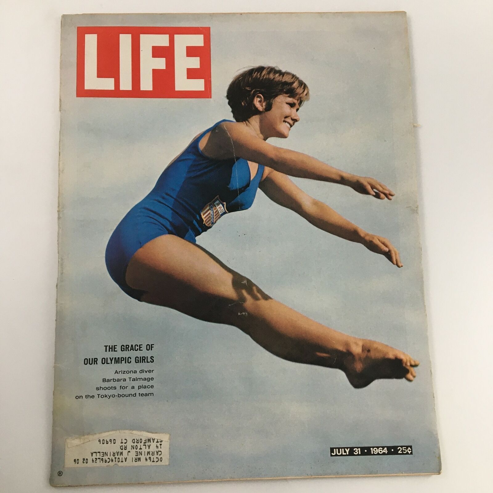 Cover of the vintage Life Magazine from July 31, 1964, featuring Olympian girl diver Barbara Talmage in a blue swimsuit, captured in mid-air as she performs a diving pose. The magazine highlights her journey and achievements in diving.