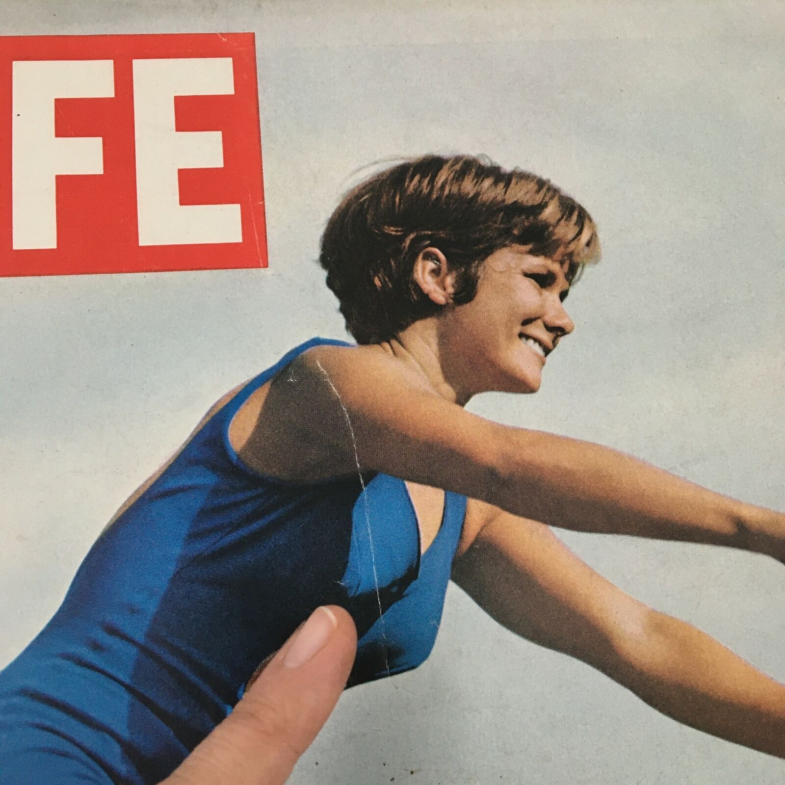 Cover of the vintage Life Magazine July 31, 1964 featuring Olympian girl diver Barbara Talmage. The magazine showcases a smiling Talmage in a blue diving suit, representing the iconic spirit of Olympic sports.