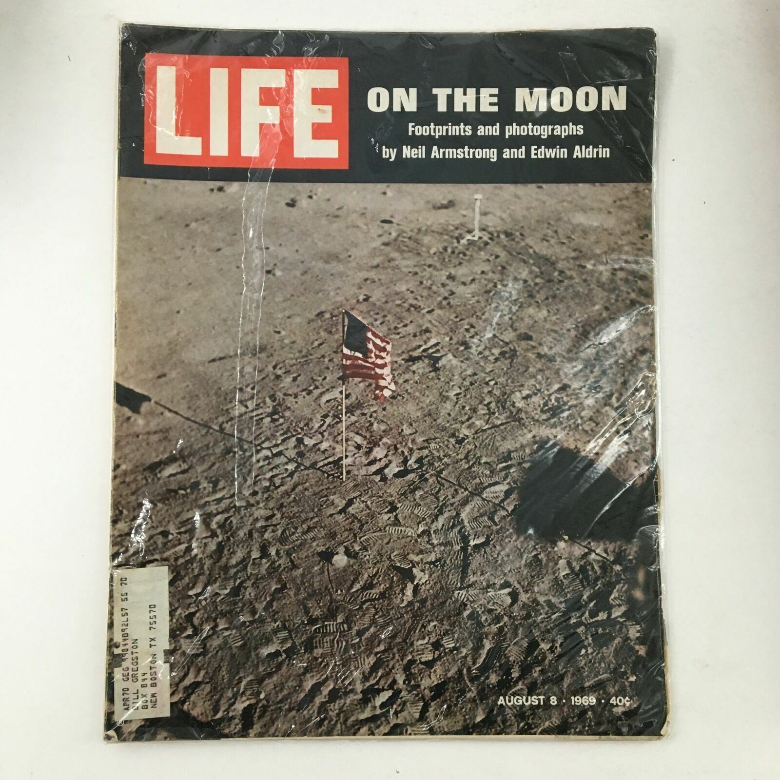 Life Magazine August 8 1969 cover featuring the moon with an American flag, capturing footprints and photographs by Neil Armstrong and Edwin Aldrin.