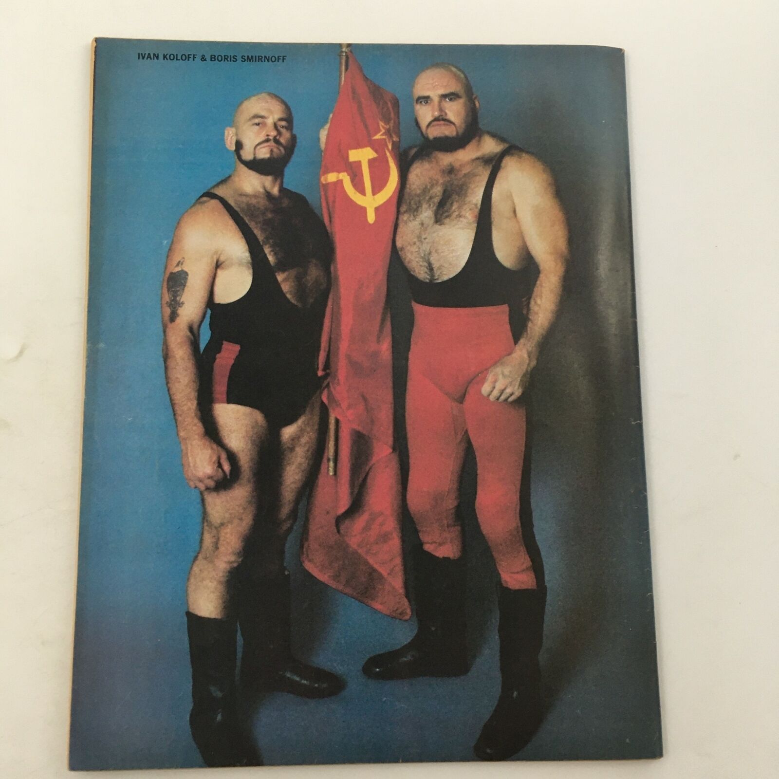 Vintage image of wrestlers Ivan Koloff and Boris Smirnoff holding a Soviet flag from The Ring's Wrestling Magazine February 1981.