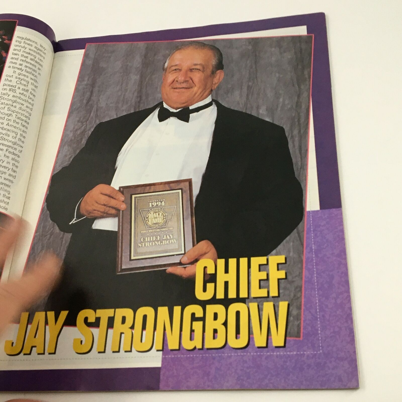 A feature from WWF Magazine February 1995 highlighting Chief Jay Strongbow posing with an award, showcasing WWE's tribute to wrestling legends.