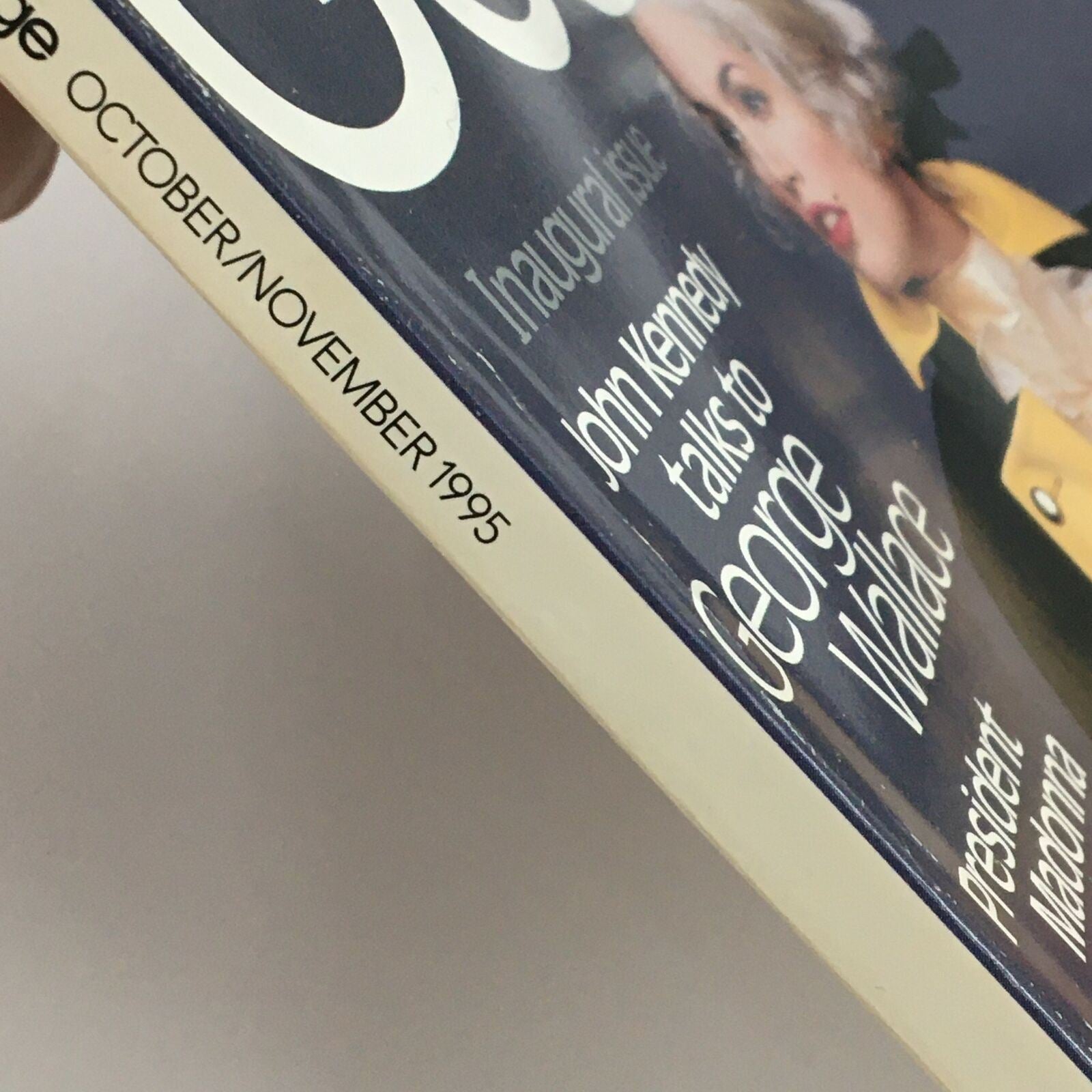 Side view of George Magazine, October/November 1995, showcasing the label detailing the inaugural issue with John Kennedy and George Wallace. The spine emphasizes the magazine's vintage appeal.
