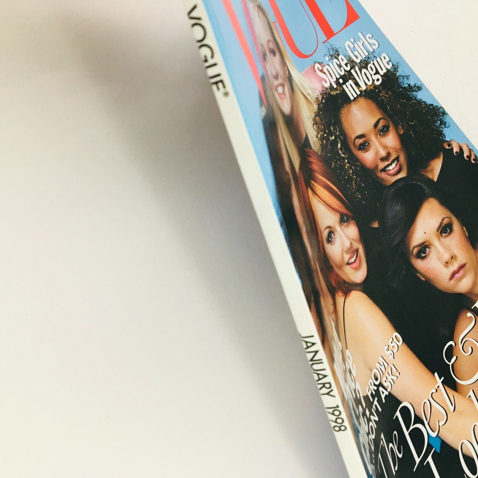Vogue Magazine January 1998 cover featuring the Spice Girls, showcasing Mel B, Emma, Victoria, Melanie C, and Geri, highlighting the fashion and pop culture of the late 90s.
