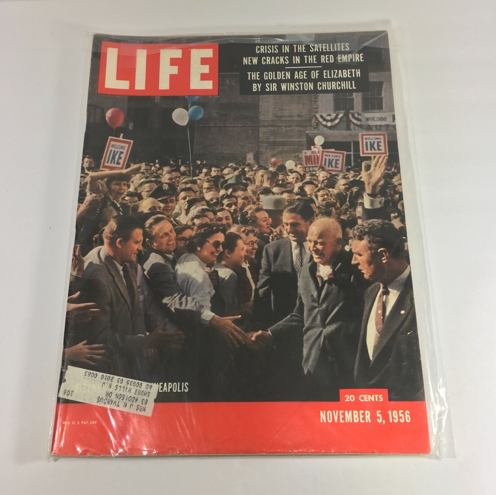 Vintage Life Magazine cover from November 5, 1956, featuring Dwight D. Eisenhower during his political campaigning in Minneapolis, showcasing a crowd excitedly welcoming him with signs and balloons.