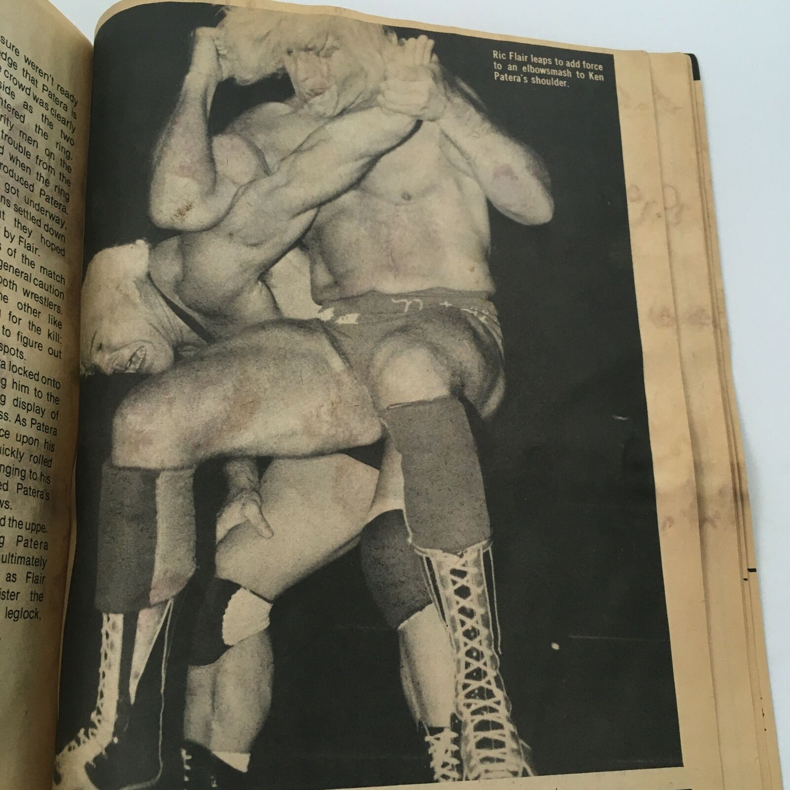 A black and white image from The Wrestler Magazine October 1981 featuring Ric Flair performing an elbow drop on Ken Patera, illustrating the excitement of professional wrestling during this era.