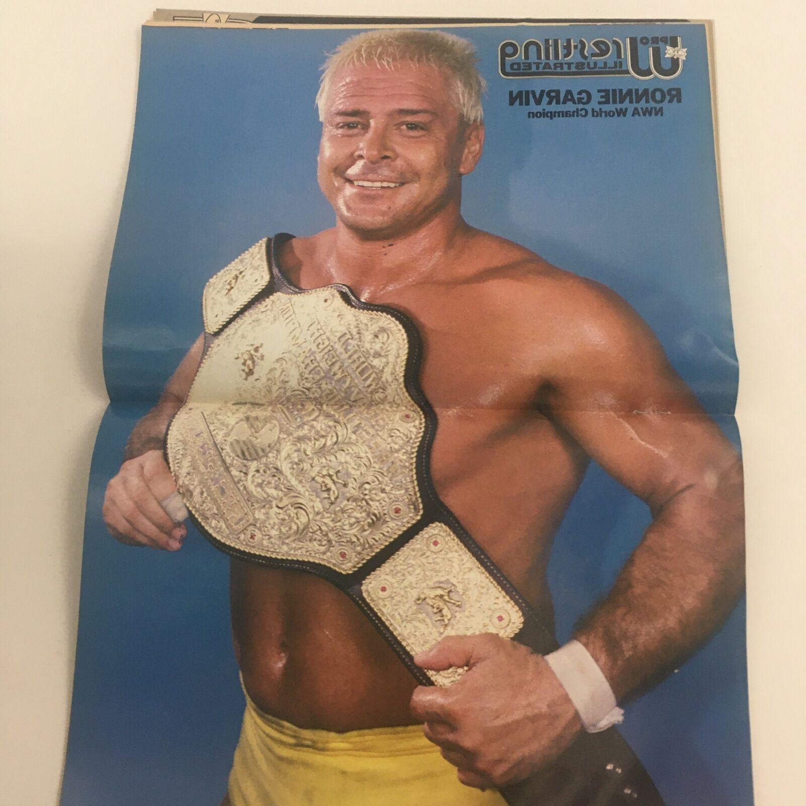 Full-page color image of Ronnie Garvin, NWA World Heavyweight Champion, holding the championship belt in Pro Wrestling Illustrated Magazine February 1988.