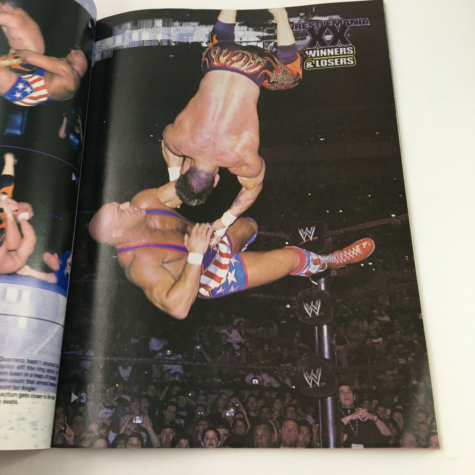 Action shot from the July 2004 Pro Wrestling Illustrated Magazine capturing a thrilling wrestling moment featuring competitors in mid-air during a match.