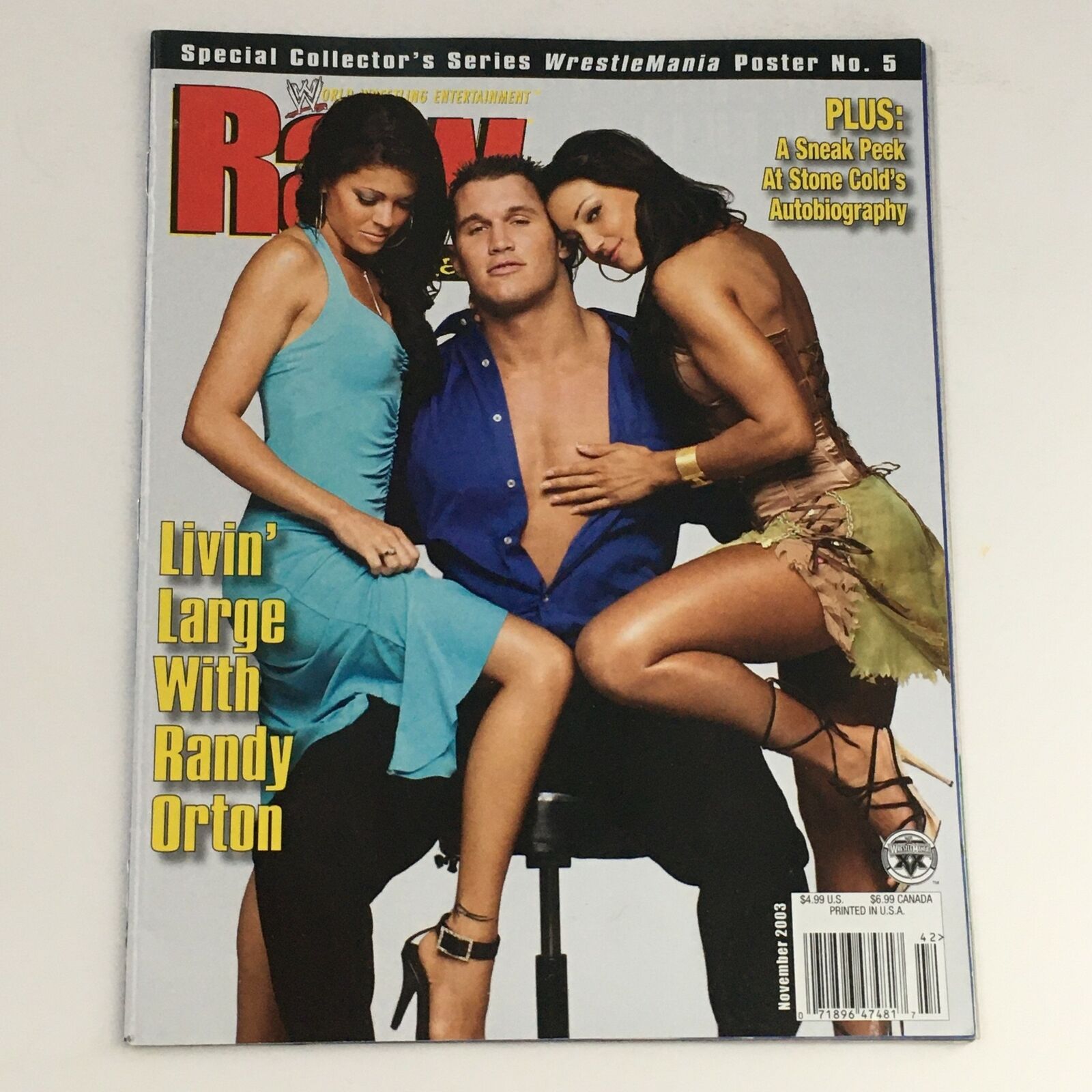 Cover of WWE Raw Magazine November 2003 featuring Randy Orton with two models, highlighting his prominence in wrestling and pop culture.