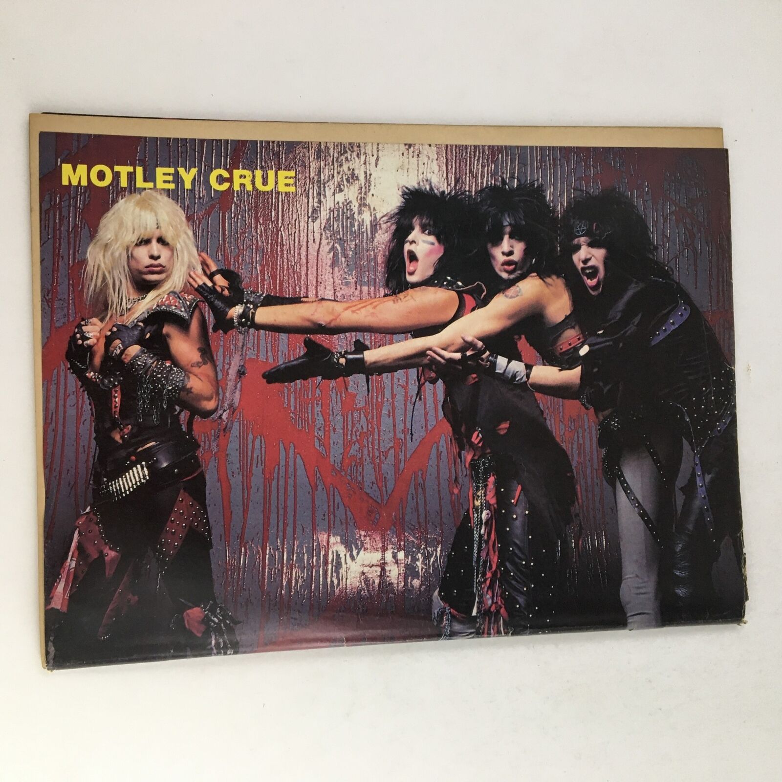 A vibrant promotional poster of Motley Crue featured in Rock Fever Magazine June 1985, Vol 2 #2, showcasing the band in their iconic style during the 1980s rock era.