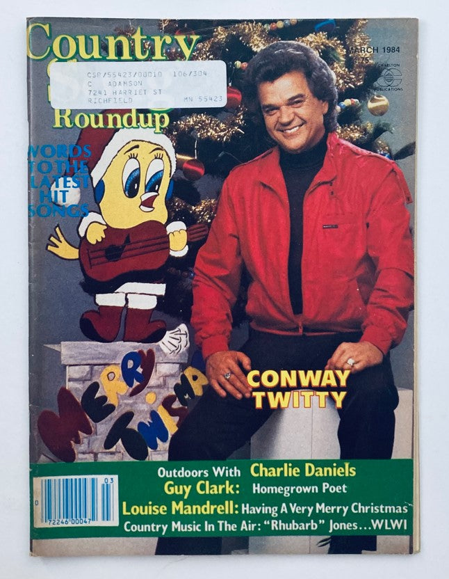 Cover of VTG Country Song Roundup Magazine March 1984 featuring Conway Twitty with a festive background and a cartoon character. This collectible magazine highlights country music stars and nostalgic themes.