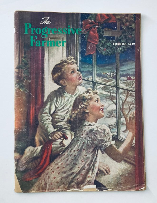 Cover of The Progressive Farmer Magazine December 1949 featuring two children gazing out of a window decorated with a holiday wreath, showcasing vintage charm.