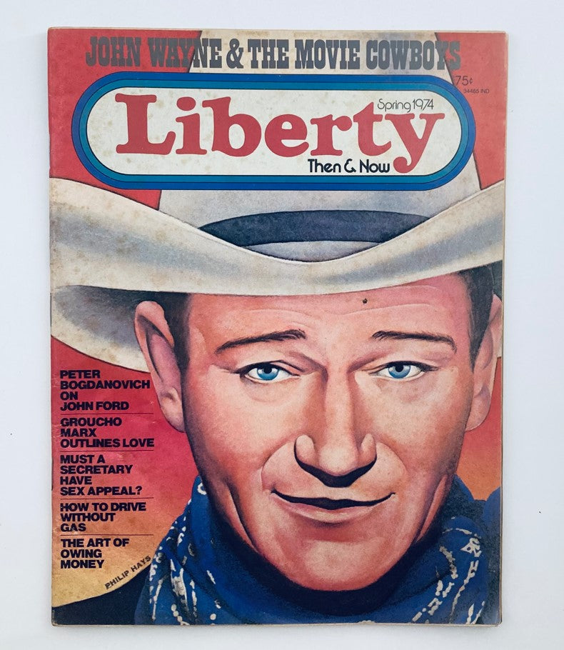 Cover of the vintage magazine 'Liberty Then & Now' Spring 1974, Volume 1, Number 12, featuring John Wayne. The cover showcases vibrant artwork and highlights movie-related content, capturing the essence of the 1970s.