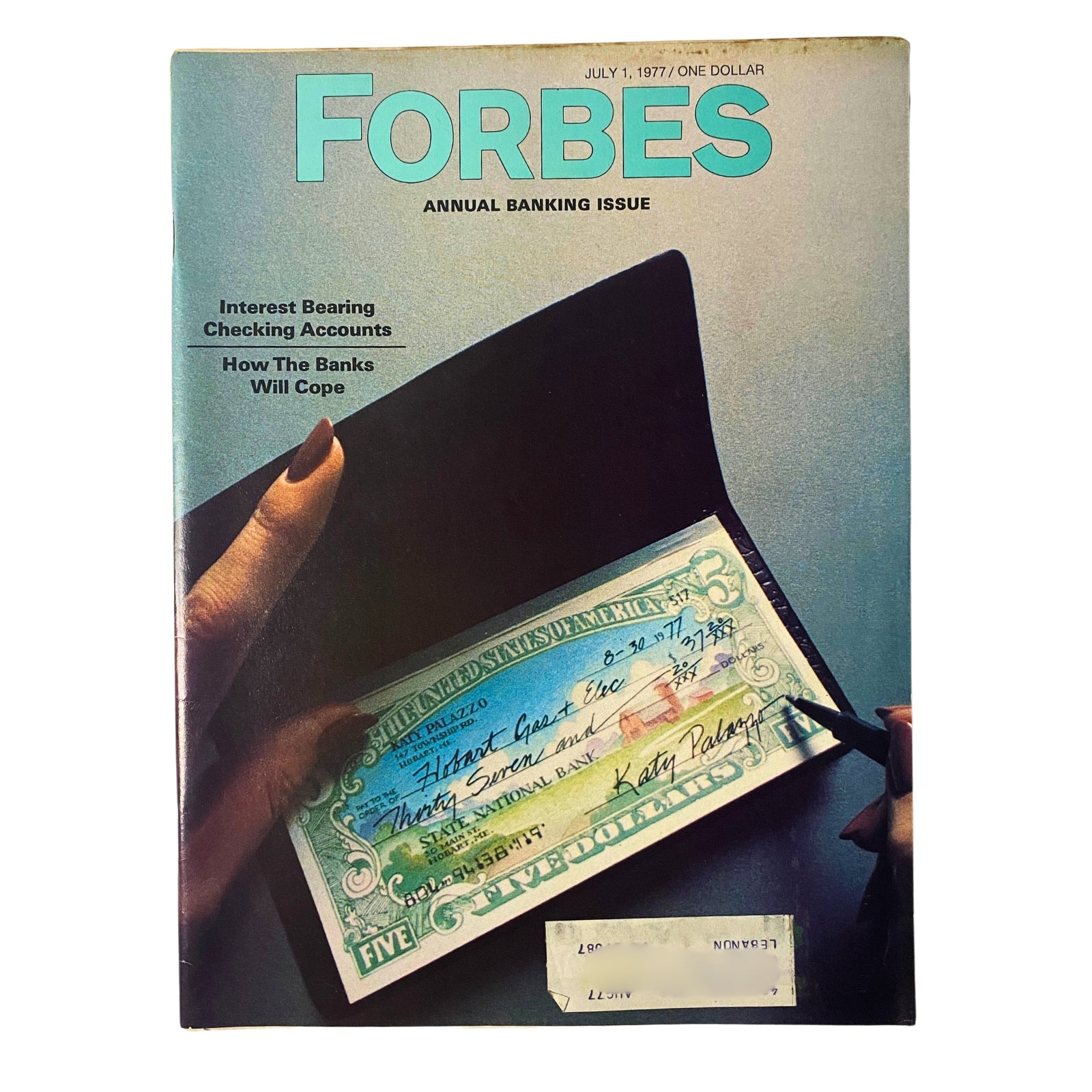 Cover of Forbes Magazine dated July 1, 1977, featuring a cover story on Interest Bearing Checking Accounts and an image of a hand holding a check.