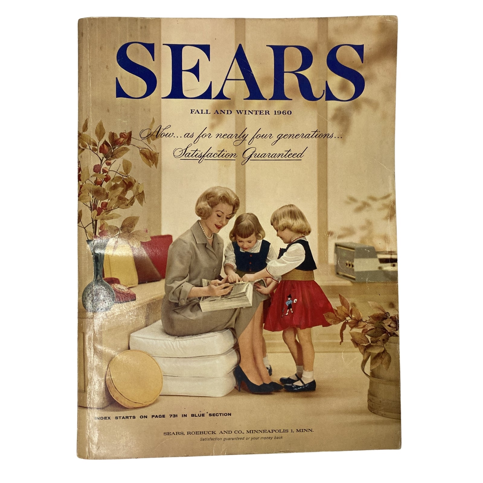 Cover of the 1960 Sears Fall and Winter Catalog featuring a stylish woman and two girls engaging in a cozy indoor setting.