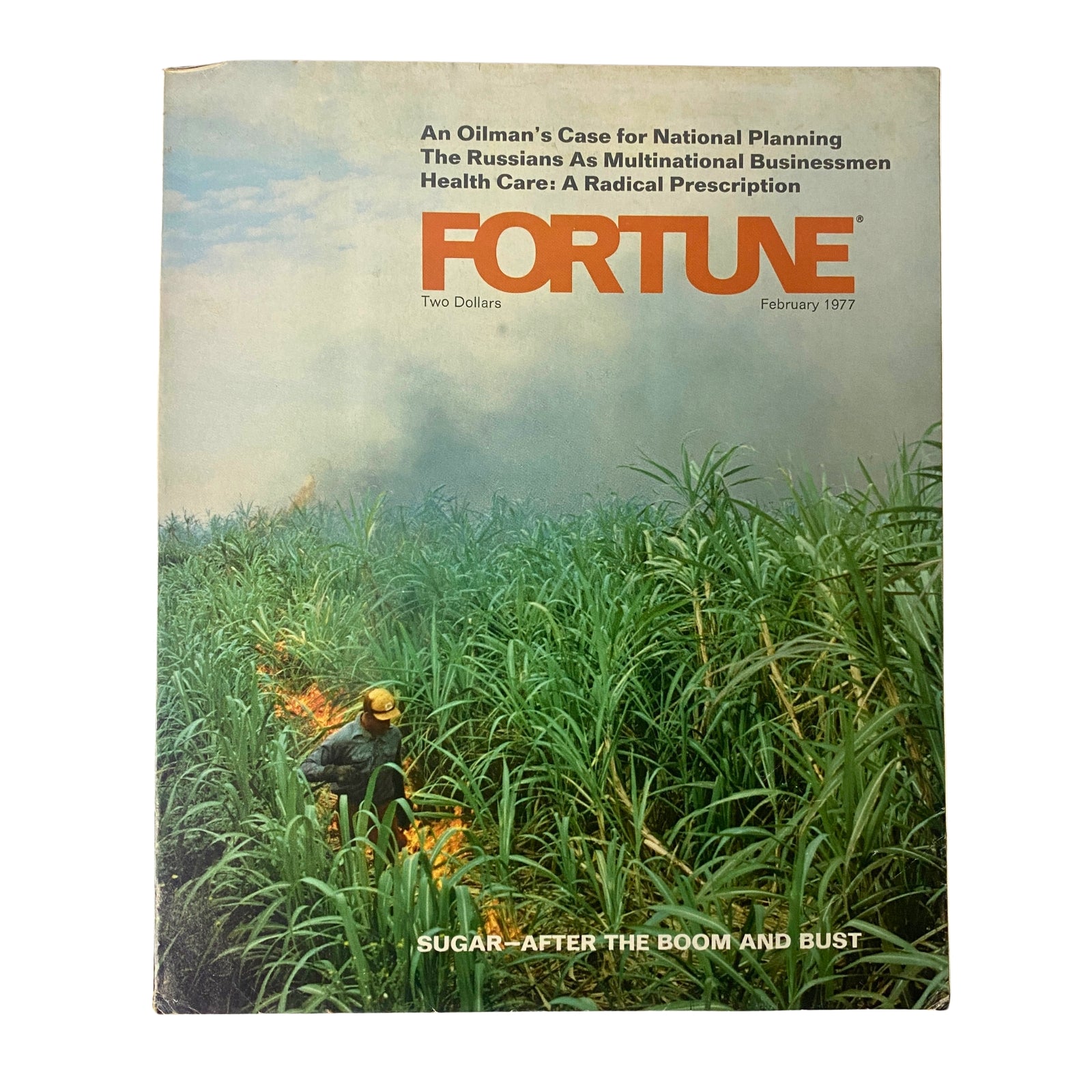 Fortune Magazine February 1977 cover featuring the article 'Sugar - After The Boom and Bust', showcasing a worker in a sugarcane field amid smoke.