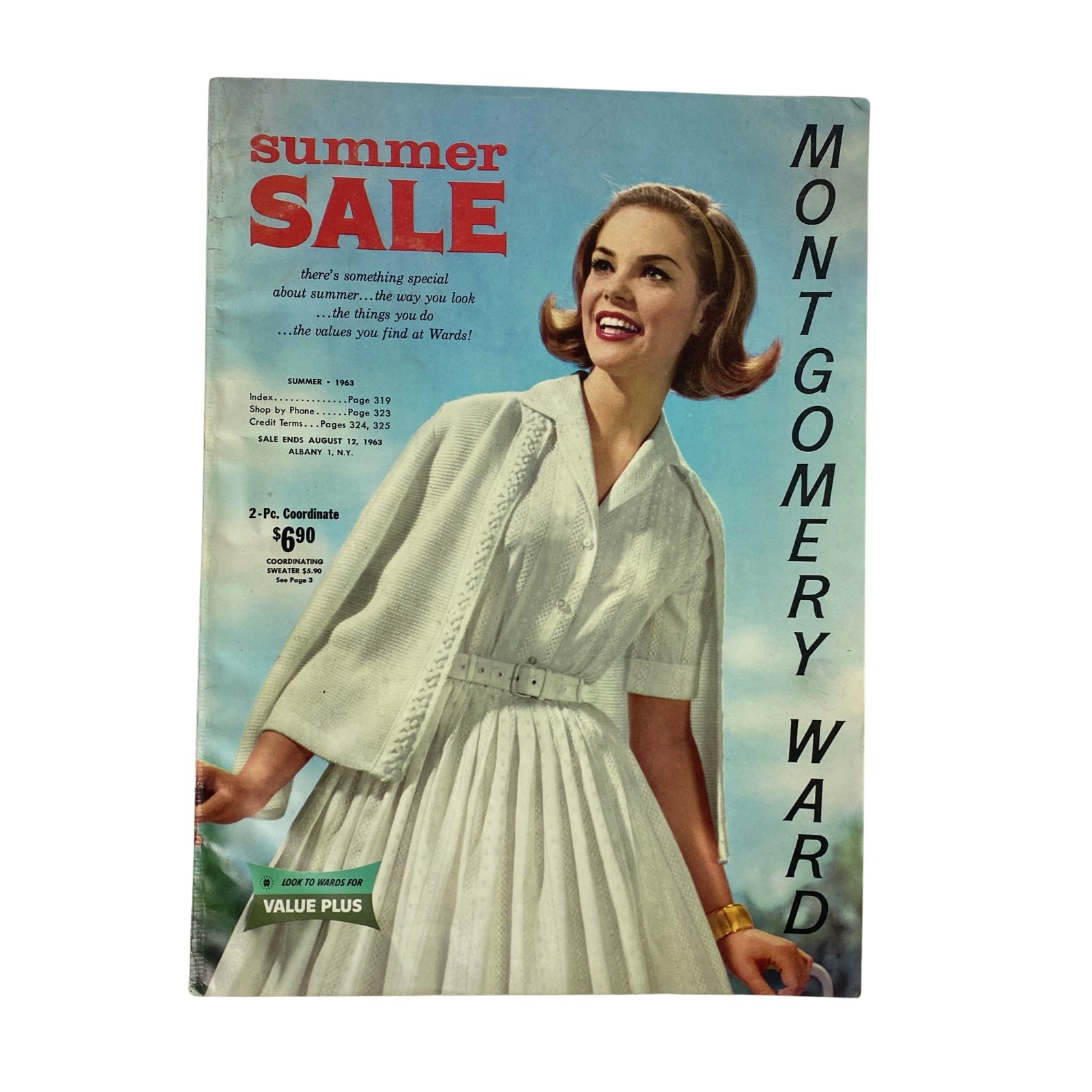 1963 Montgomery Ward Summer Catalog cover featuring a smiling woman in a stylish white dress with a caption about a summer sale.