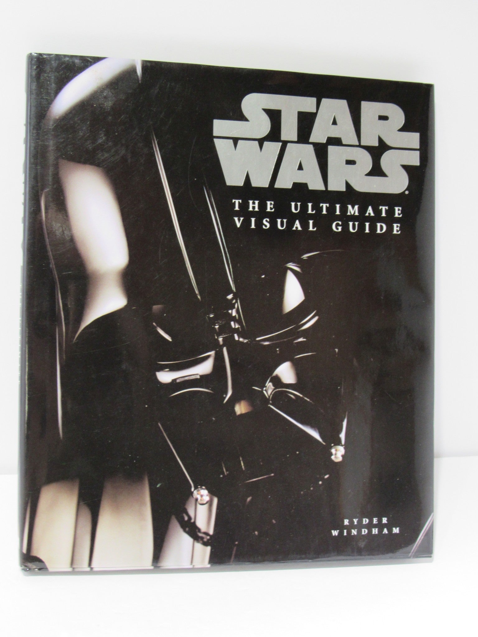Cover image of 'Star Wars: The Ultimate Visual Guide' by Ryder Windham, featuring a close-up of a lightsaber hilt on a dark background, showcasing the book's title in bold font.