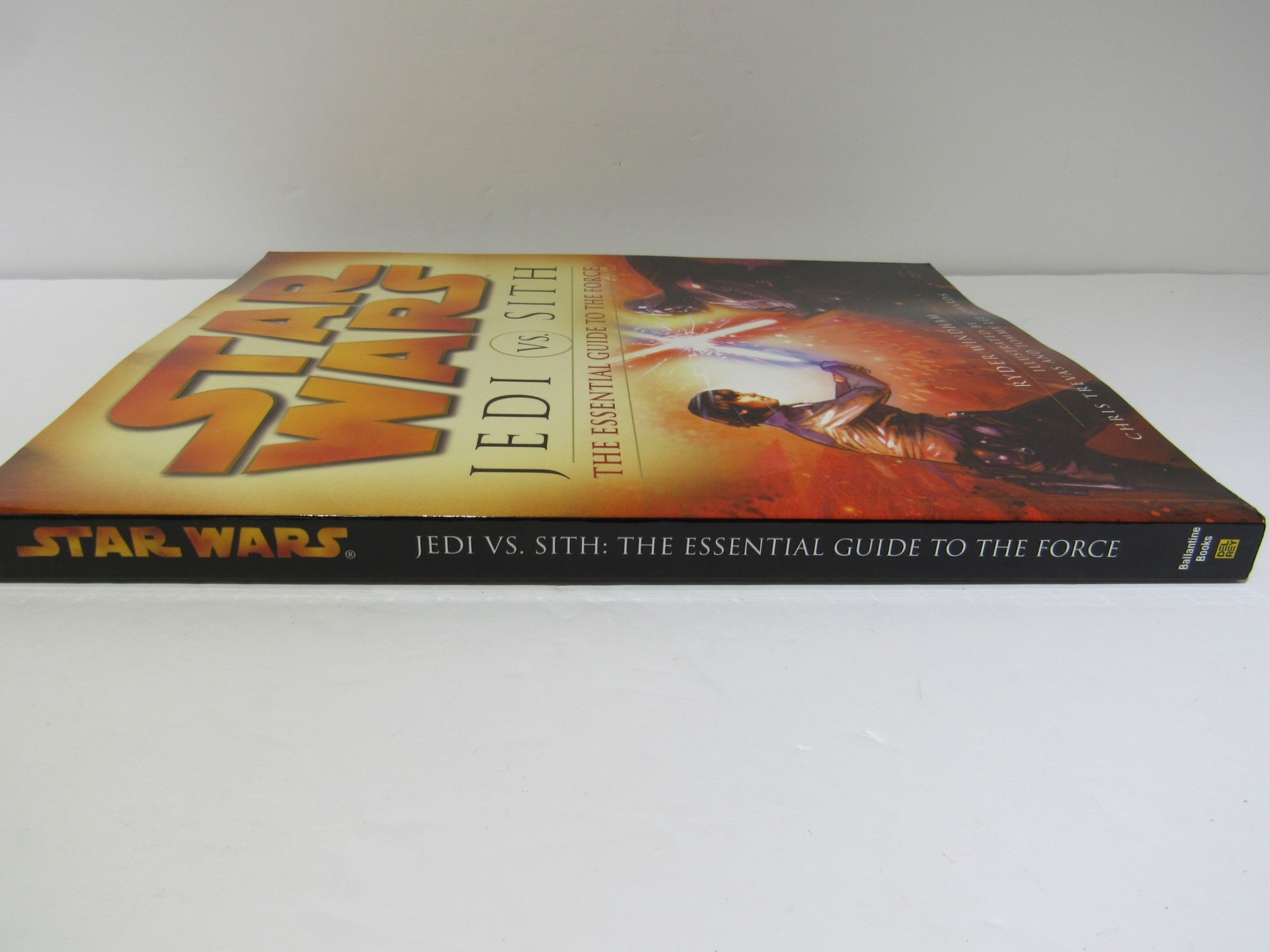 Star Wars Jedi vs. Sith: The Essential Guide to the Force book cover showcasing its vibrant design and spine, highlighting key aspects of the Force and the galactic conflict.