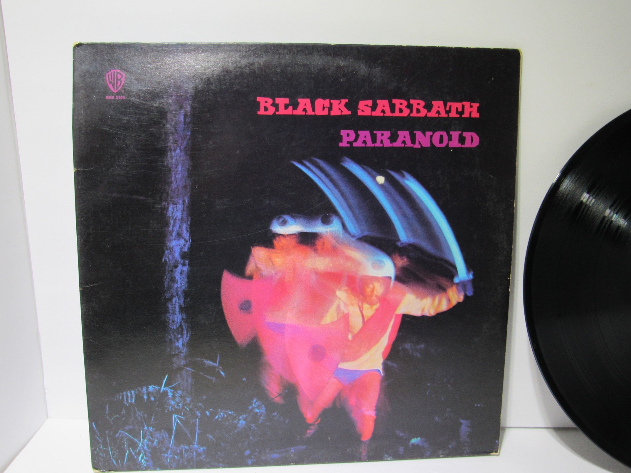 Cover of Black Sabbath Paranoid Warner Bros. Records LP BSK 3104 featuring vibrant artwork, graded VG+