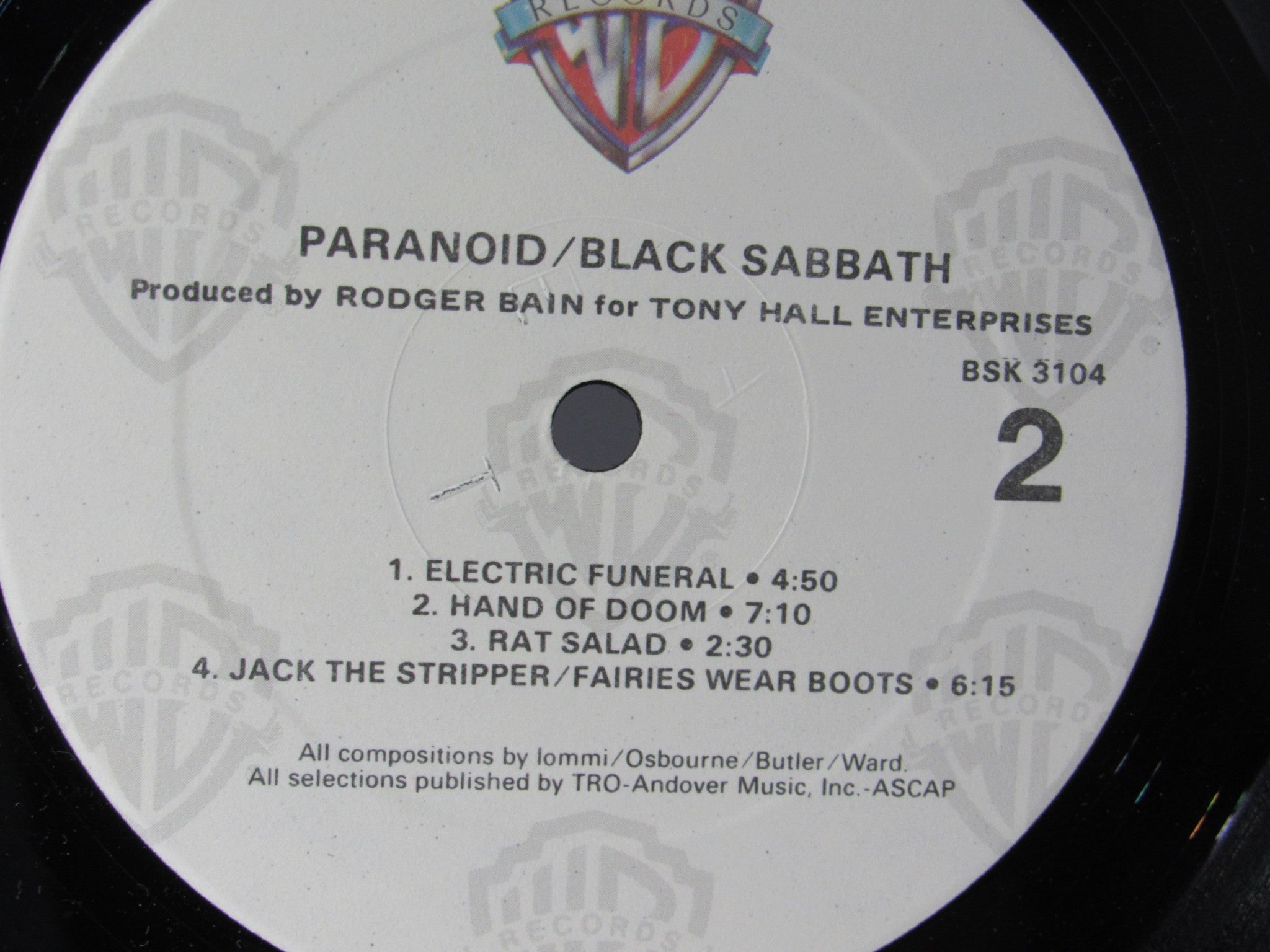 Label of the Black Sabbath Paranoid Warner Bros. Records LP BSK 3104 showcasing song titles and production details, grade VG+
