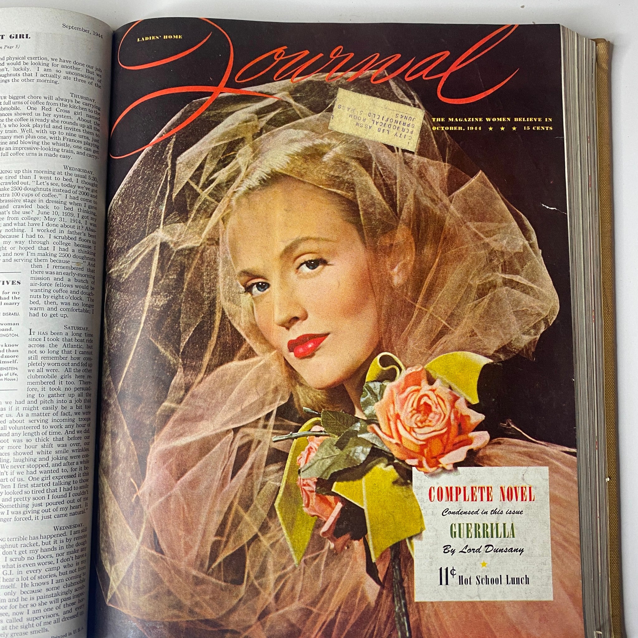 Cover of the Ladies' Home Journal from October 1944, featuring a woman in a veil holding a rose, emphasizing fashion and feminine beauty of the 1940s.