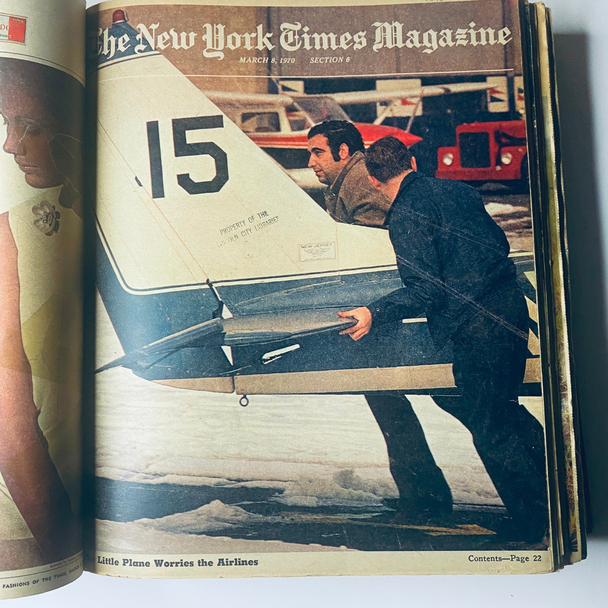 The New York Times Library Edition Bound Magazine presents a vintage photo of two men handling an aircraft, featured in the March 8, 1970 issue. This image highlights aviation topics relevant to that era.