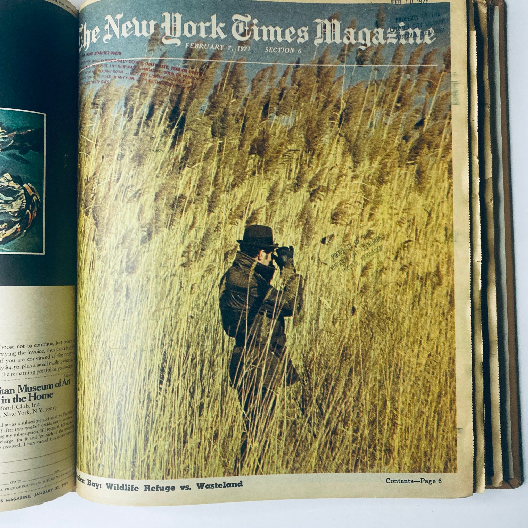 Cover image of The New York Times Library Edition Bound Magazine featuring a man photographing wildlife in a field of tall grasses, January - February 1971.