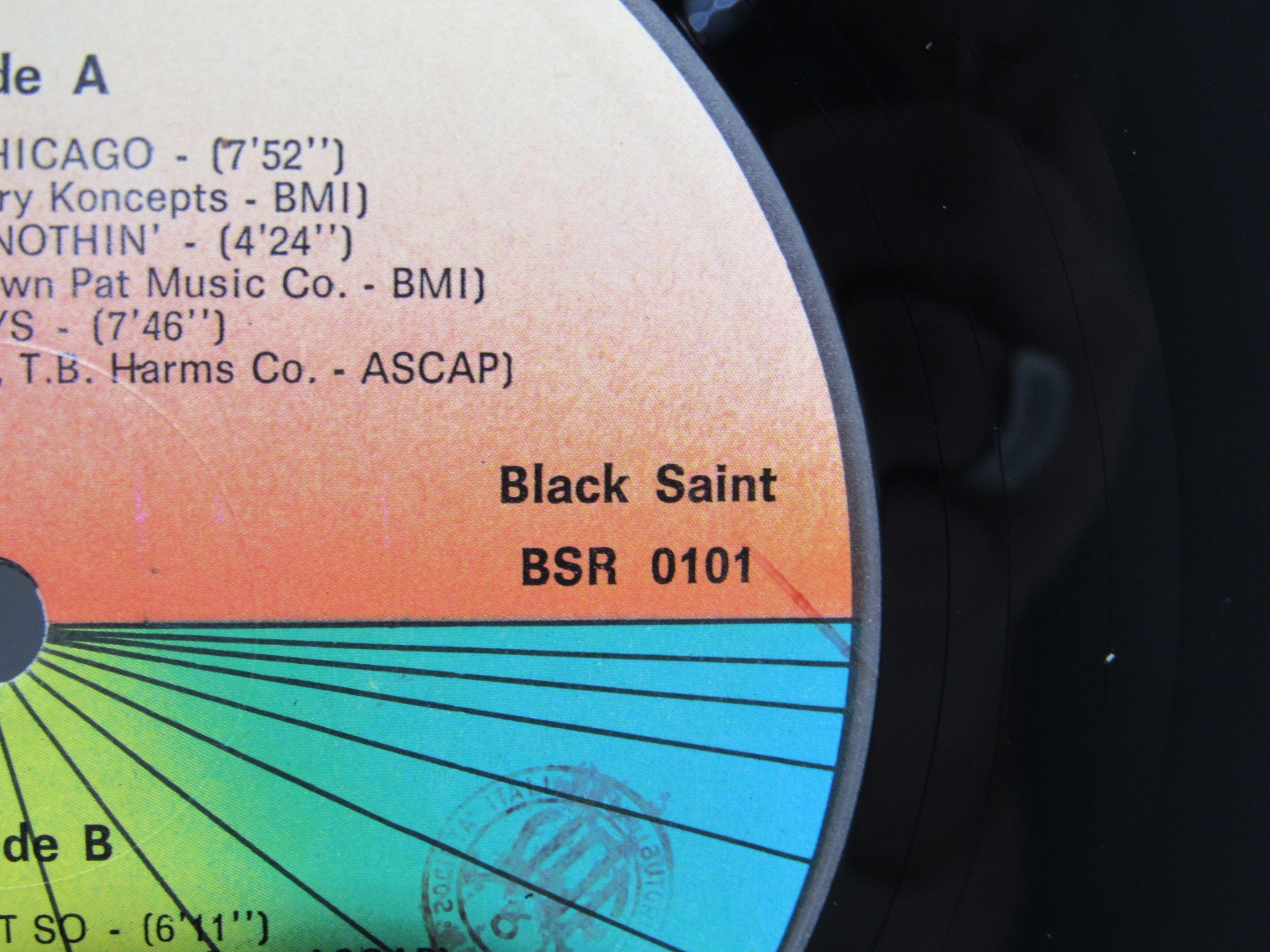 Detailed view of the record label from 'Sun Ra Arkestra: Reflections In Blue Black Saint BSR 0101', featuring color gradient and track listings.