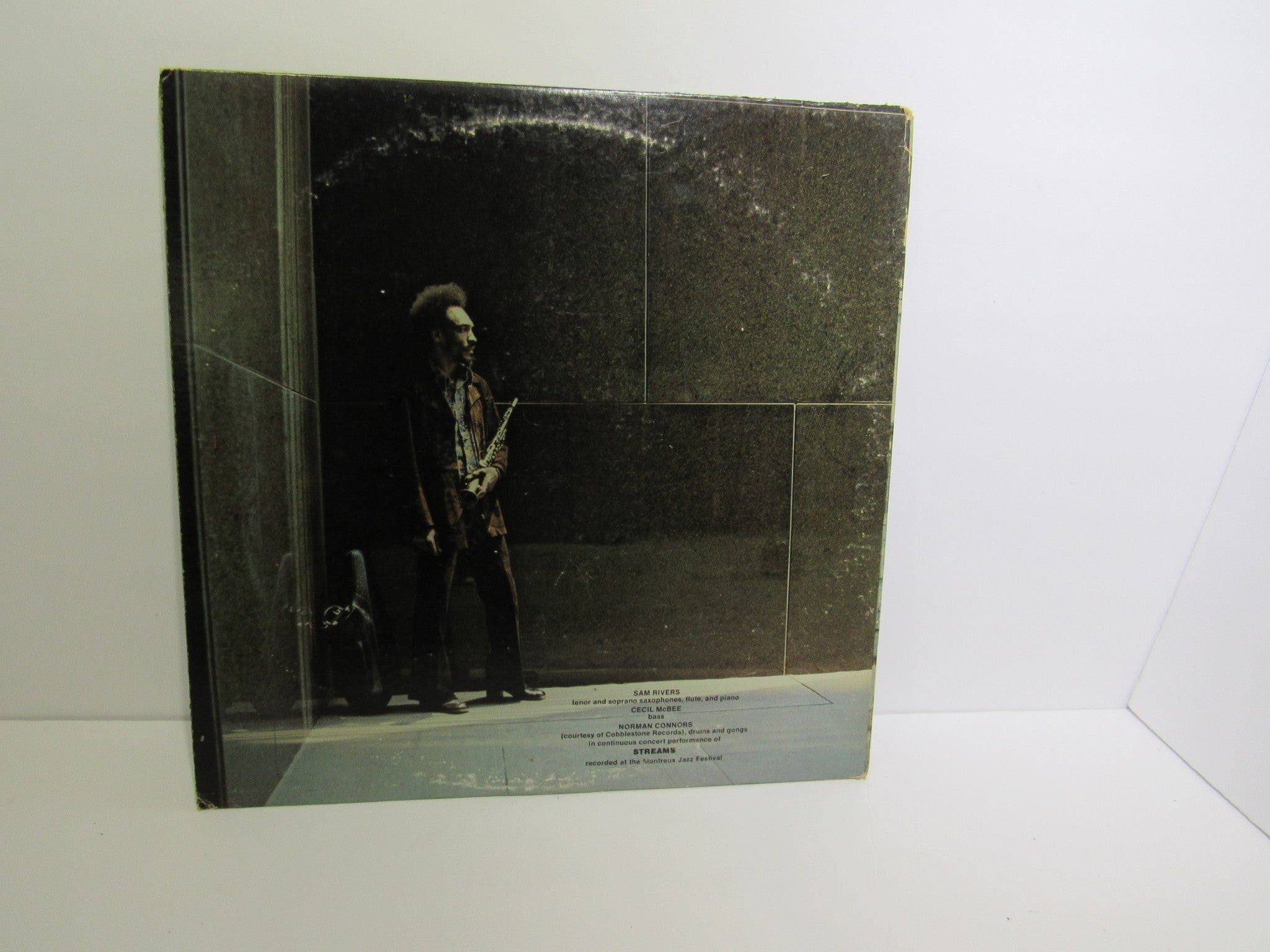 Back cover of Sam Rivers: Streams Impulse! AS-9251 Gatefold Stereo Quadraphonic LP depicting Sam Rivers in a dramatic light, with a focus on the textured cover design.